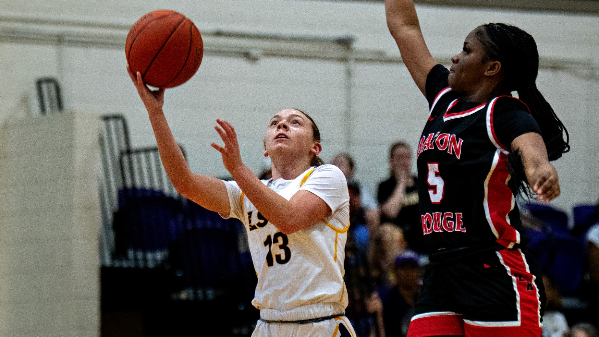 Bella Henry drives to the hoop against Baton Rouge CC.