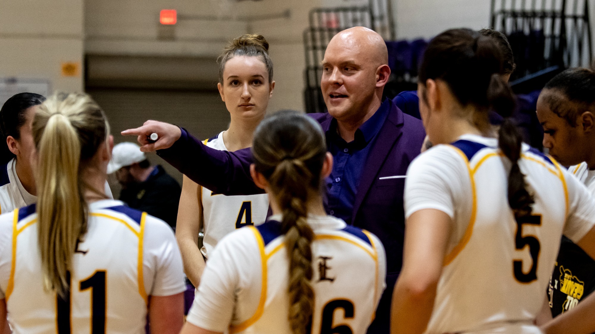 Coach Beckmann talks to his players during a game inside the HPRE Center.