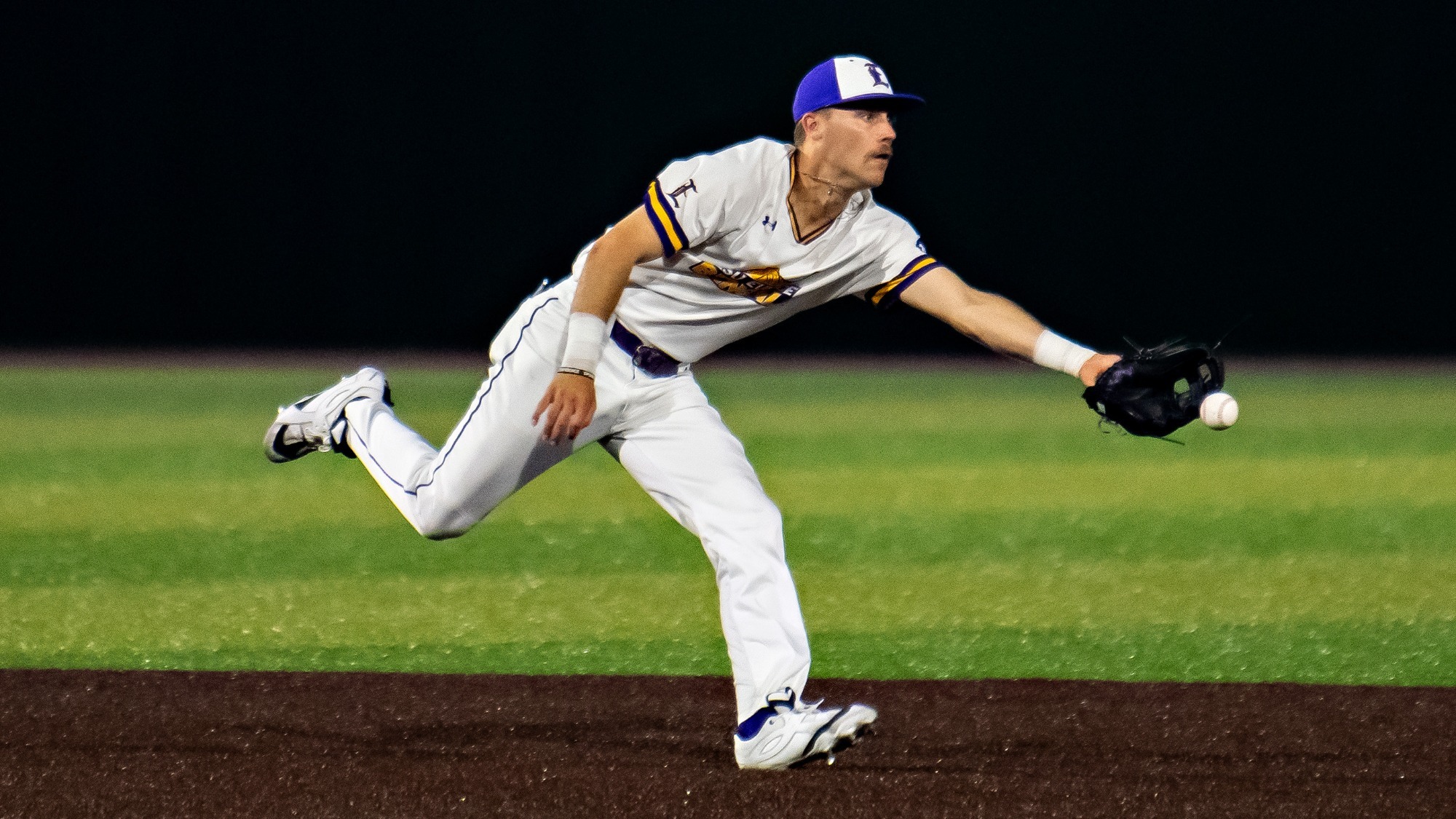 Jake Smith tosses the ball to second base during a game.