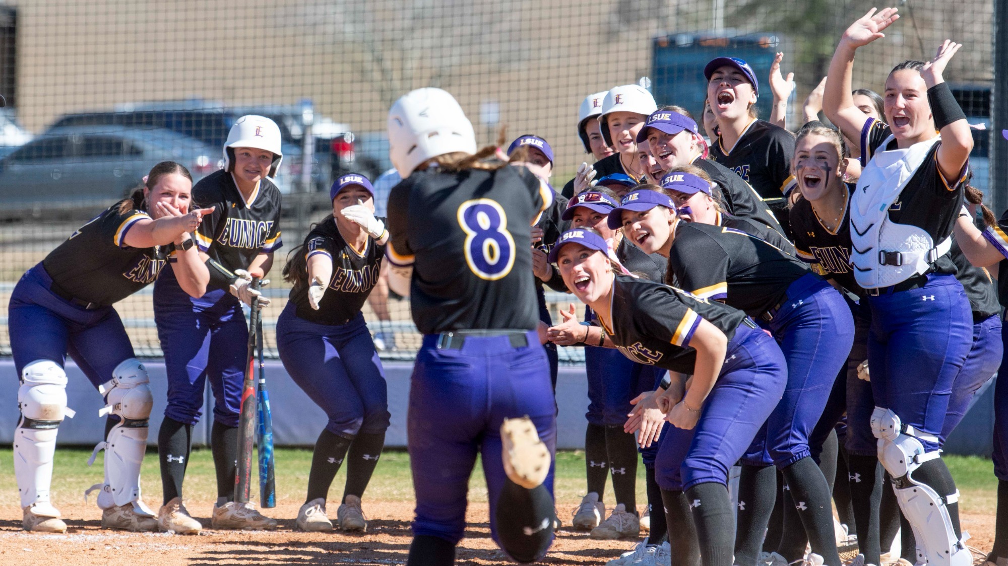 Jordan Stanley is met by her teammates after hitting a home run.