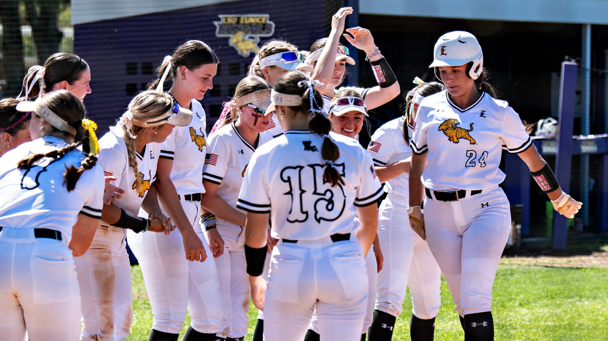 Makinley Harris is met by her teammates at home plate after a home run vs. Angelina.