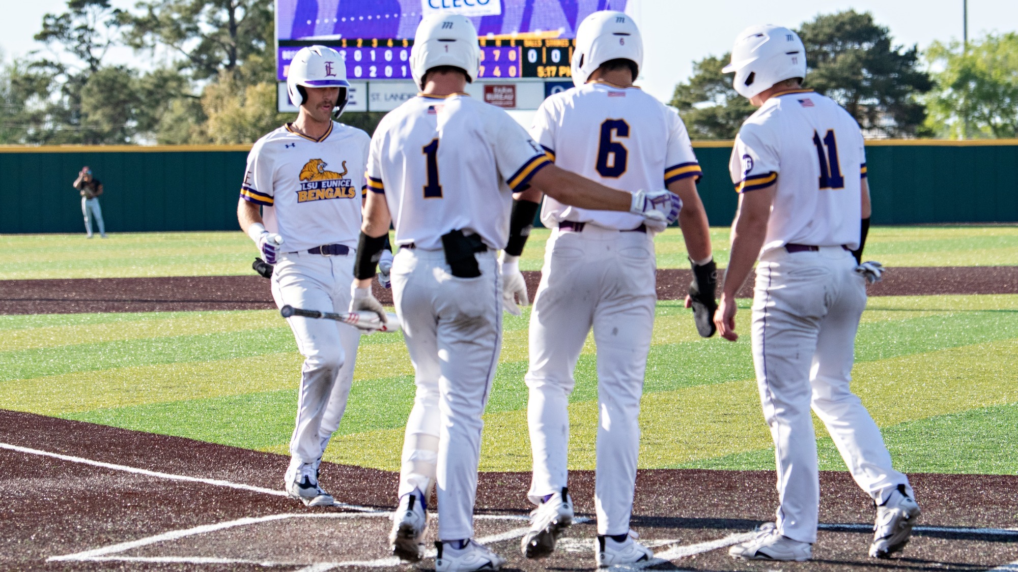 Jake Smith is met by teammates after hitting a home run vs. Bossier Parish.