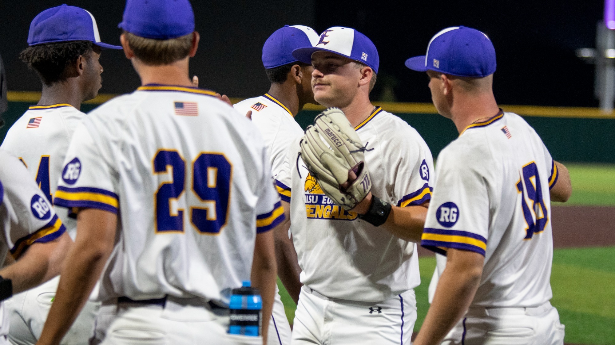 Hudson Spangler is welcomed by teammates after ending an inning.