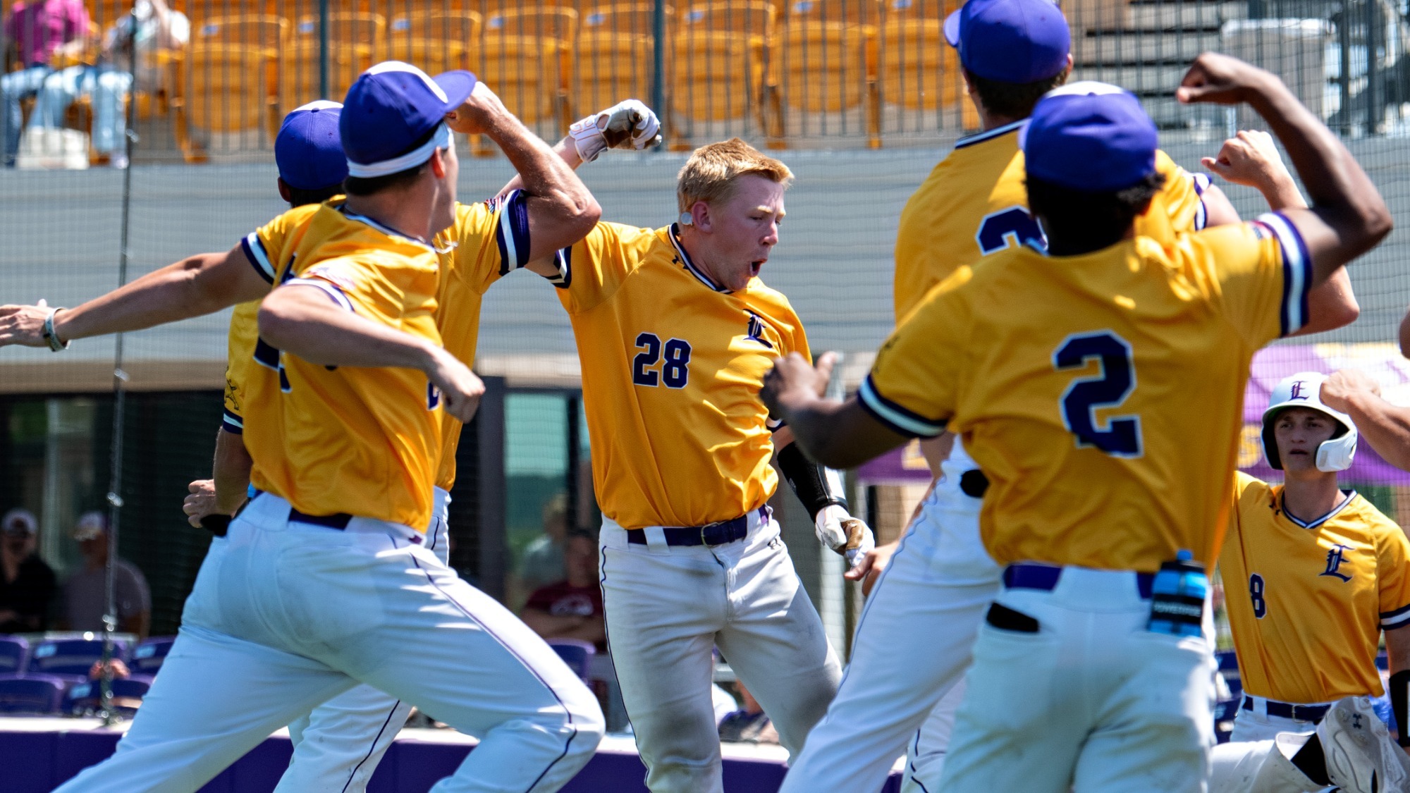 Andrew Clapinski celebrates with teammates after hitting a home run.