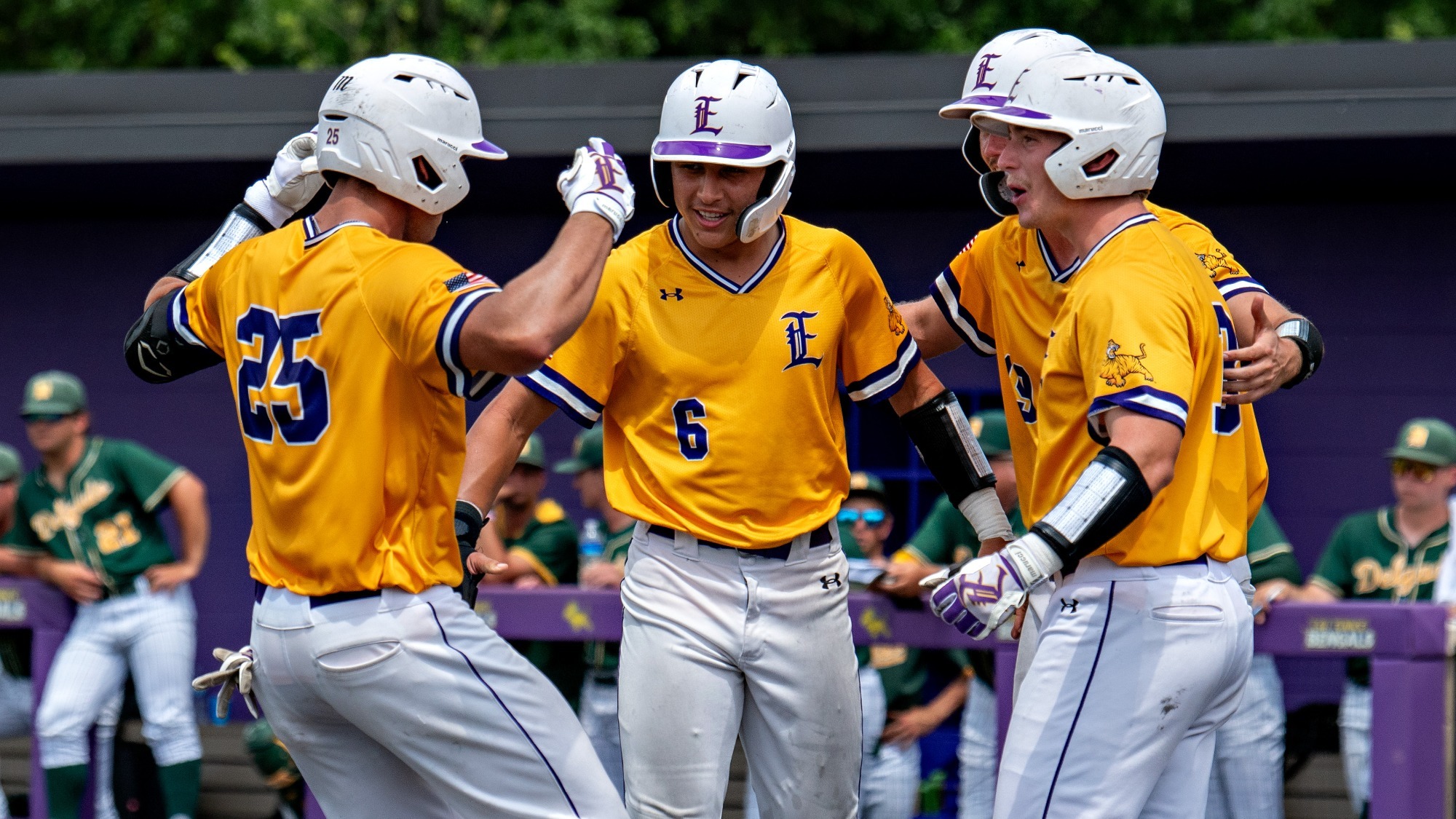 Mason Bordelon is met by teammates after hitting a home run.