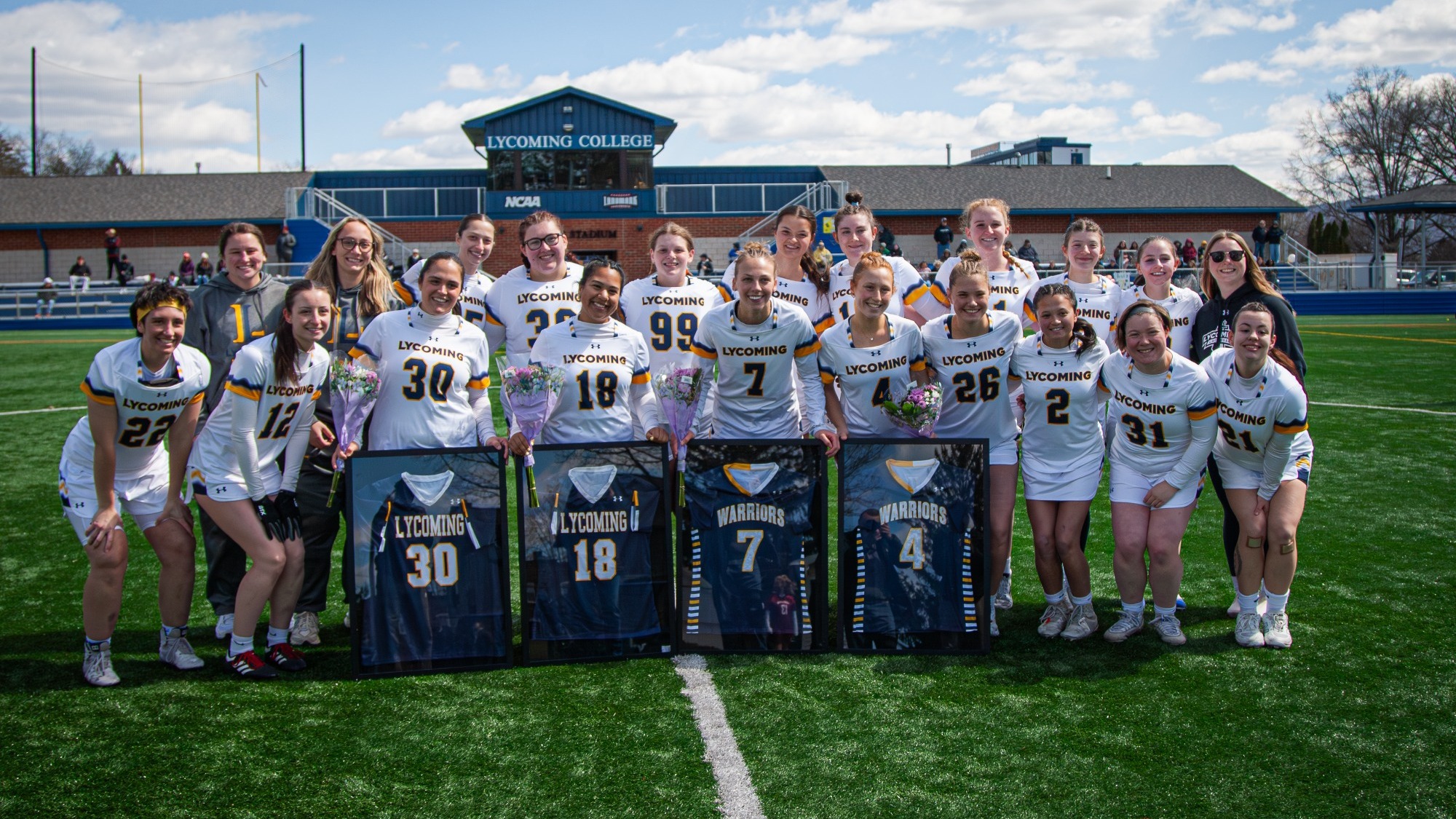 2026 Women's Lacrosse Team with Seniors in front - Riley Block, Anna Glantz,  Gabriella Fugon, Autumn Shahan
