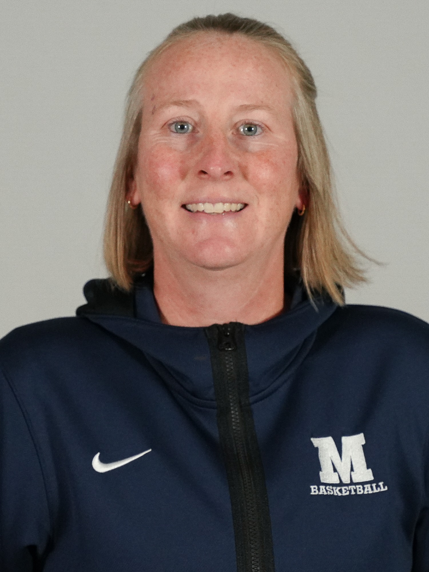 A headshot of head women's basketball coach KJ Krasco.