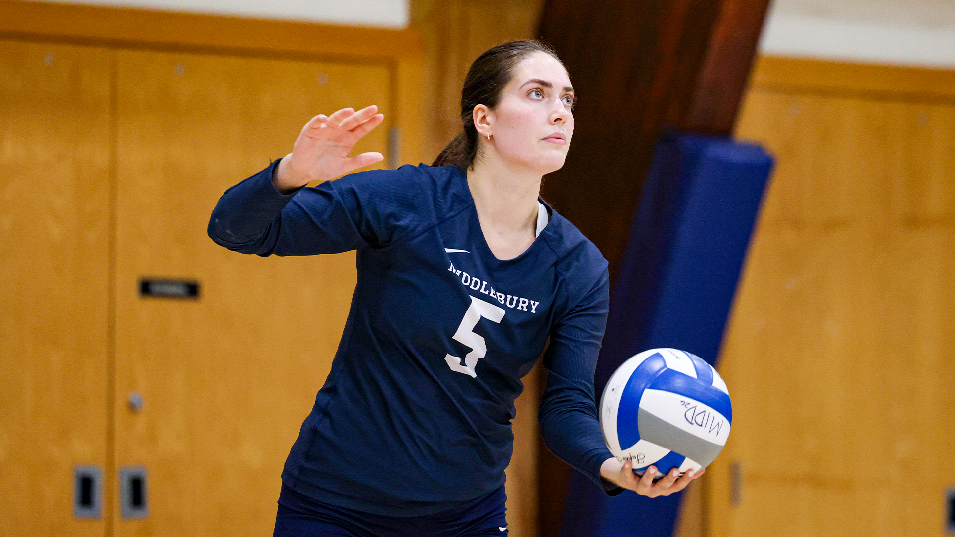 Chloe Cunniffe prepares to serve during Middlebury's regular-season match against Tufts.