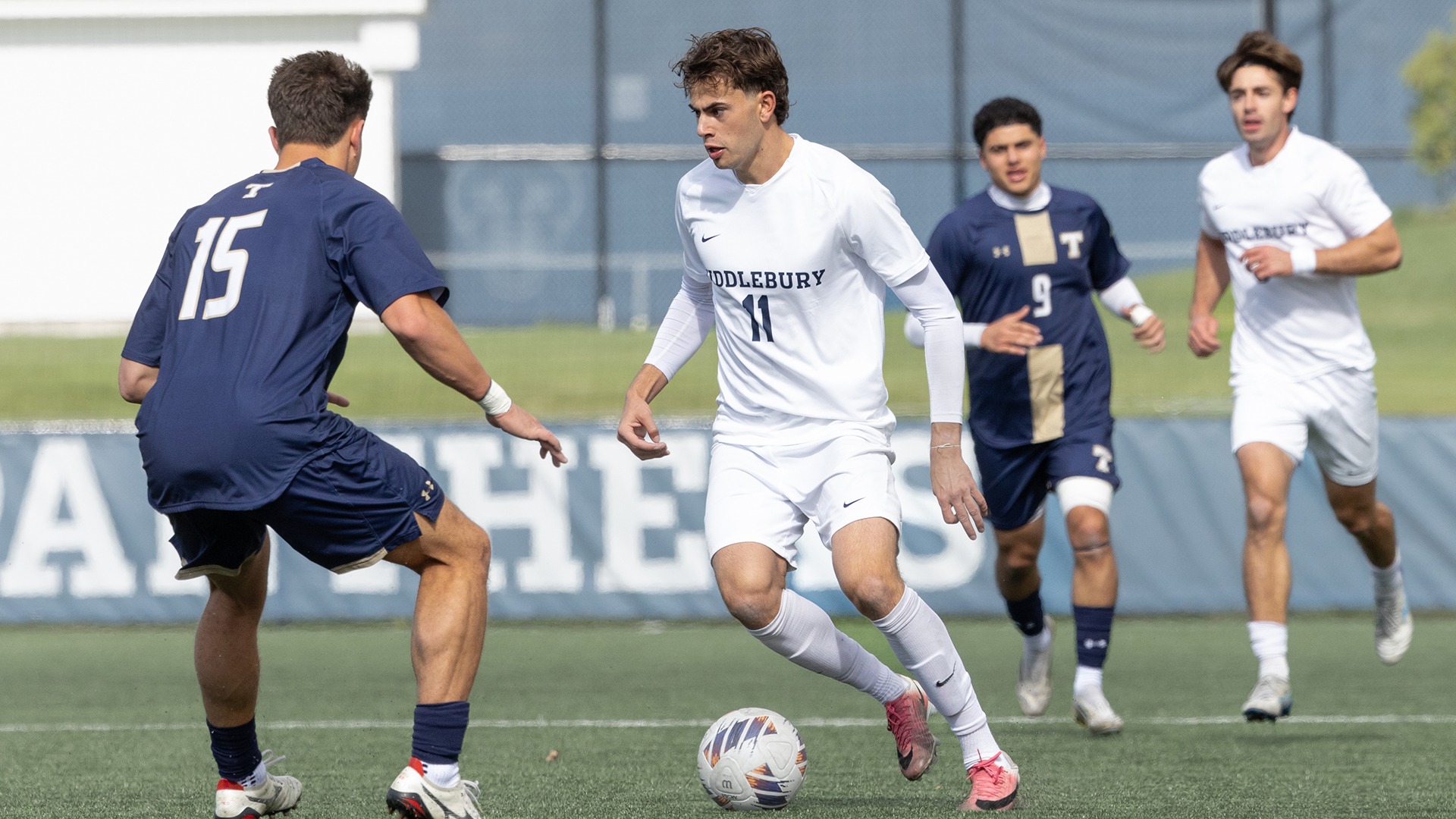 Will Sawin attempts to dribble around a defender during Middlebury's game against Trinity.
