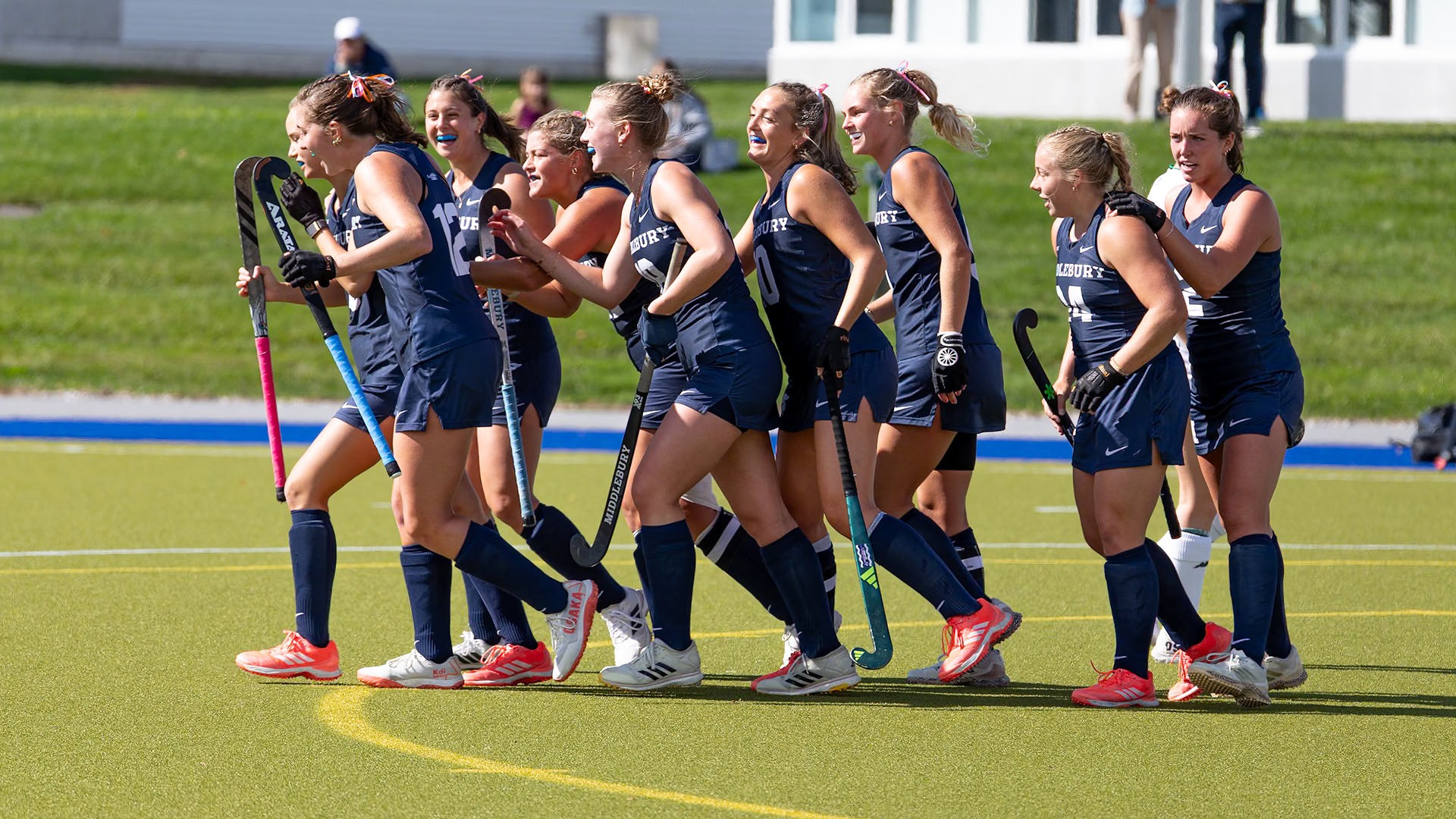 The Middlebury field hockey team celebrates after scoring a goal against Endicott.