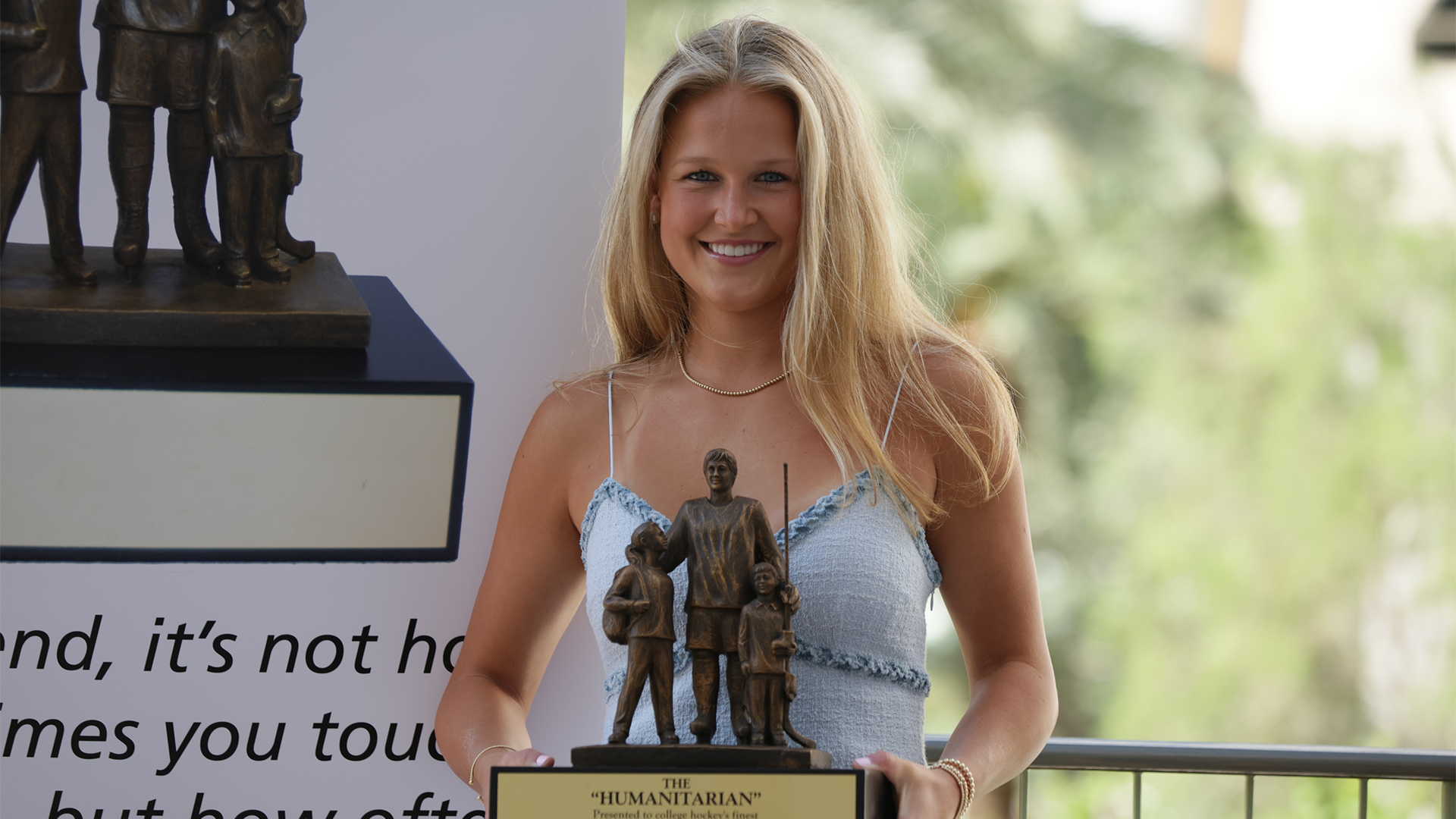 Meg Simon pictured with the 2026 Hockey Humanitarian Award trophy.