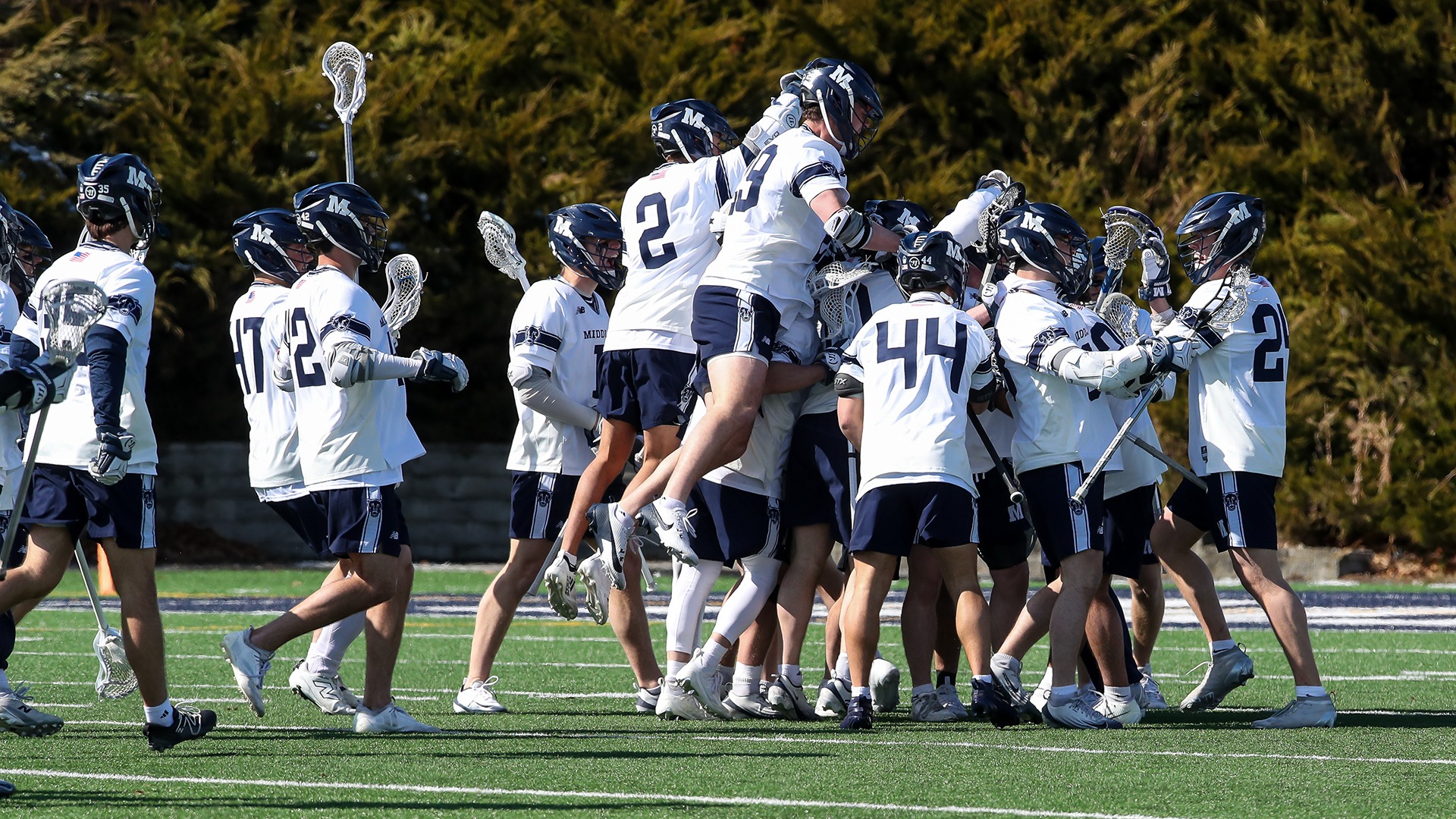 The Middlebury men's lacrosse team celebrates a goal against Bates during the 2026 season.