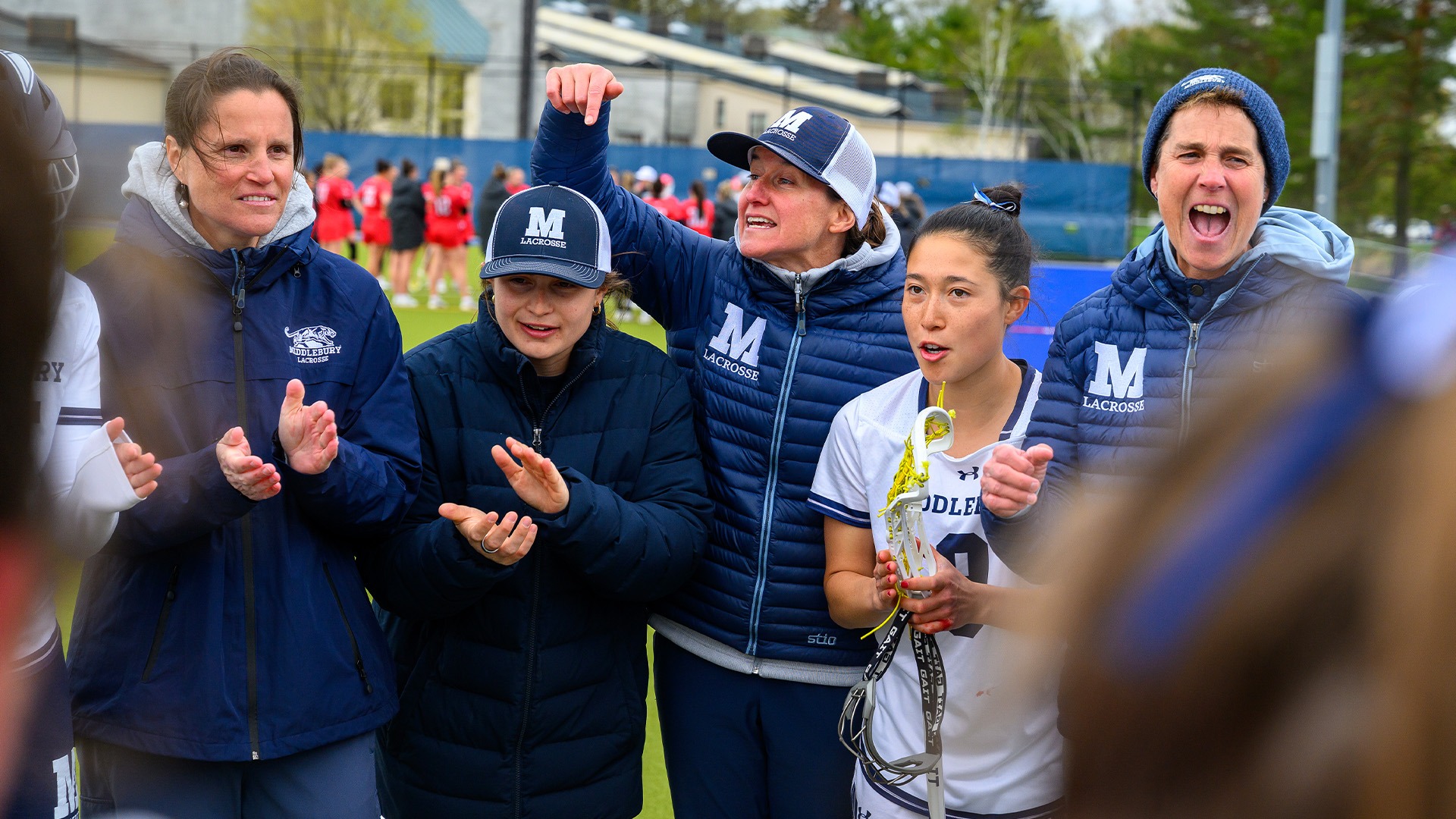 The Middlebury women's lacrosse coaching staff celebrate after winning the 2026 NESCAC Championship.
