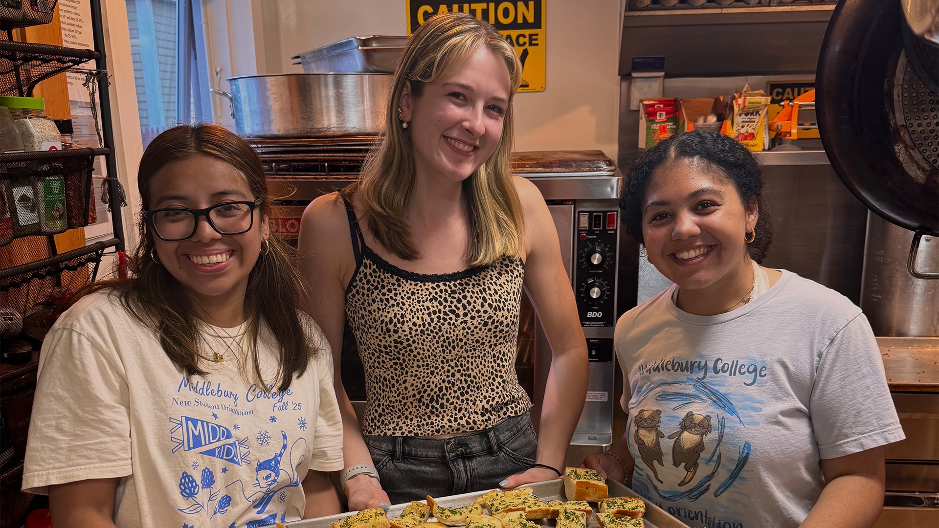 Brooke Dolan pictured with two other Middlebury volunteers making food for the residents of the Charter House Coalition.