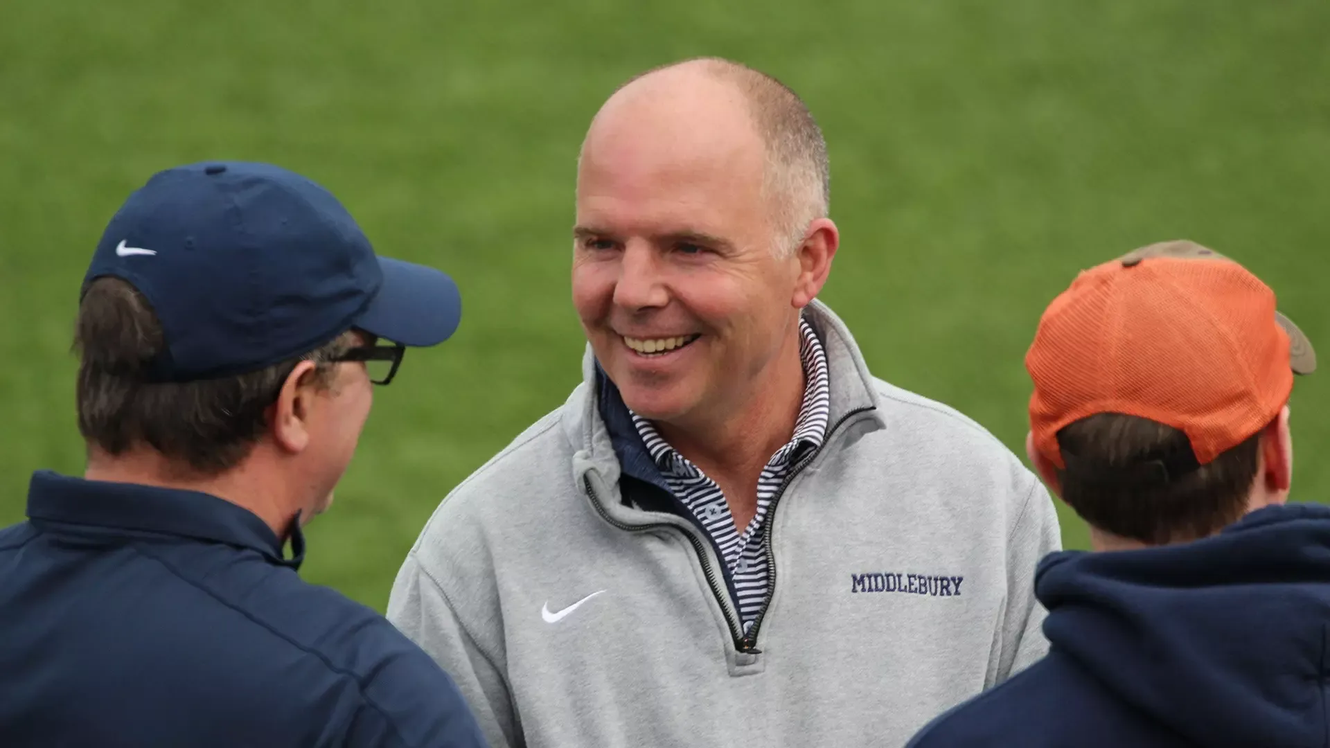 A photo of former director of athletics and men's lacrosse coach Erin Quinn '86 interacting with fans.