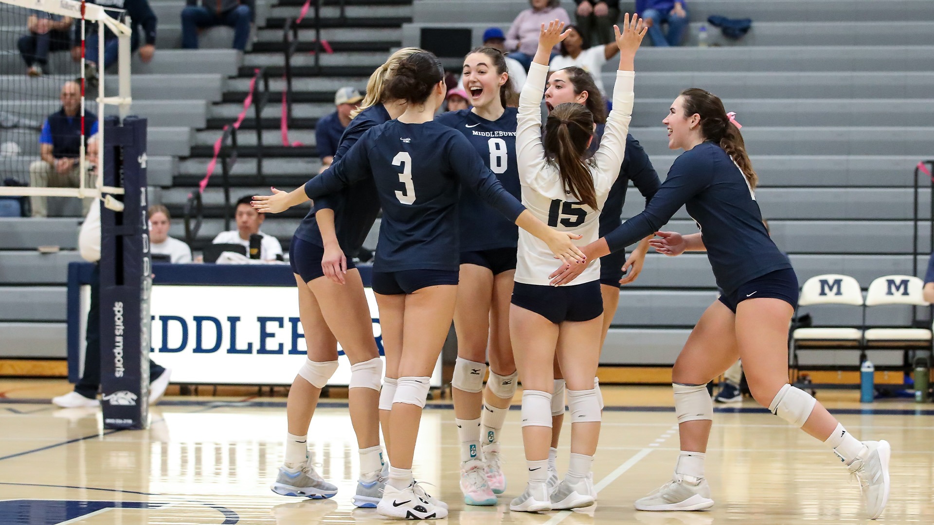 The Middlebury volleyball team celebrates after a point against Colby.