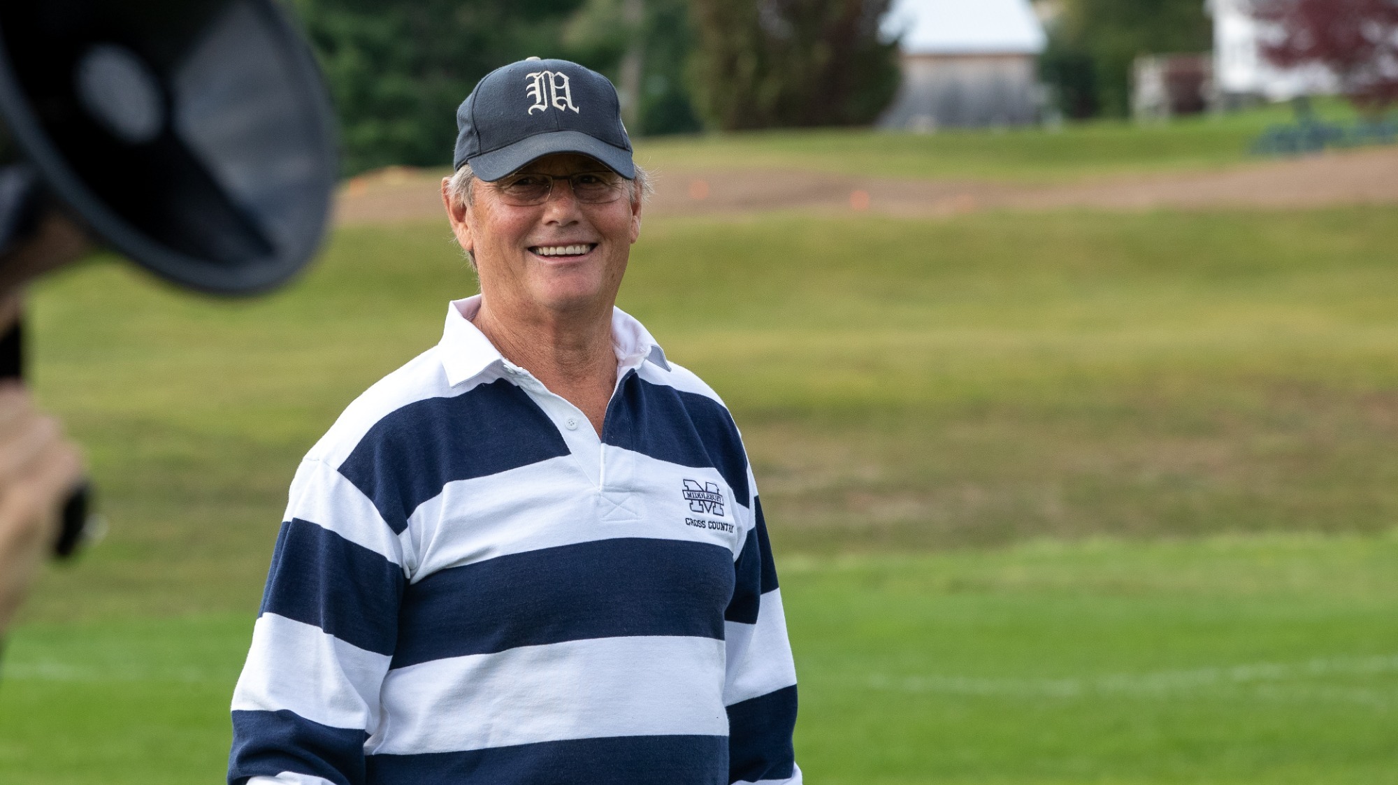Former Middlebury cross country head coach Terry Aldrich smiles at the 2021 Aldrich Invitational