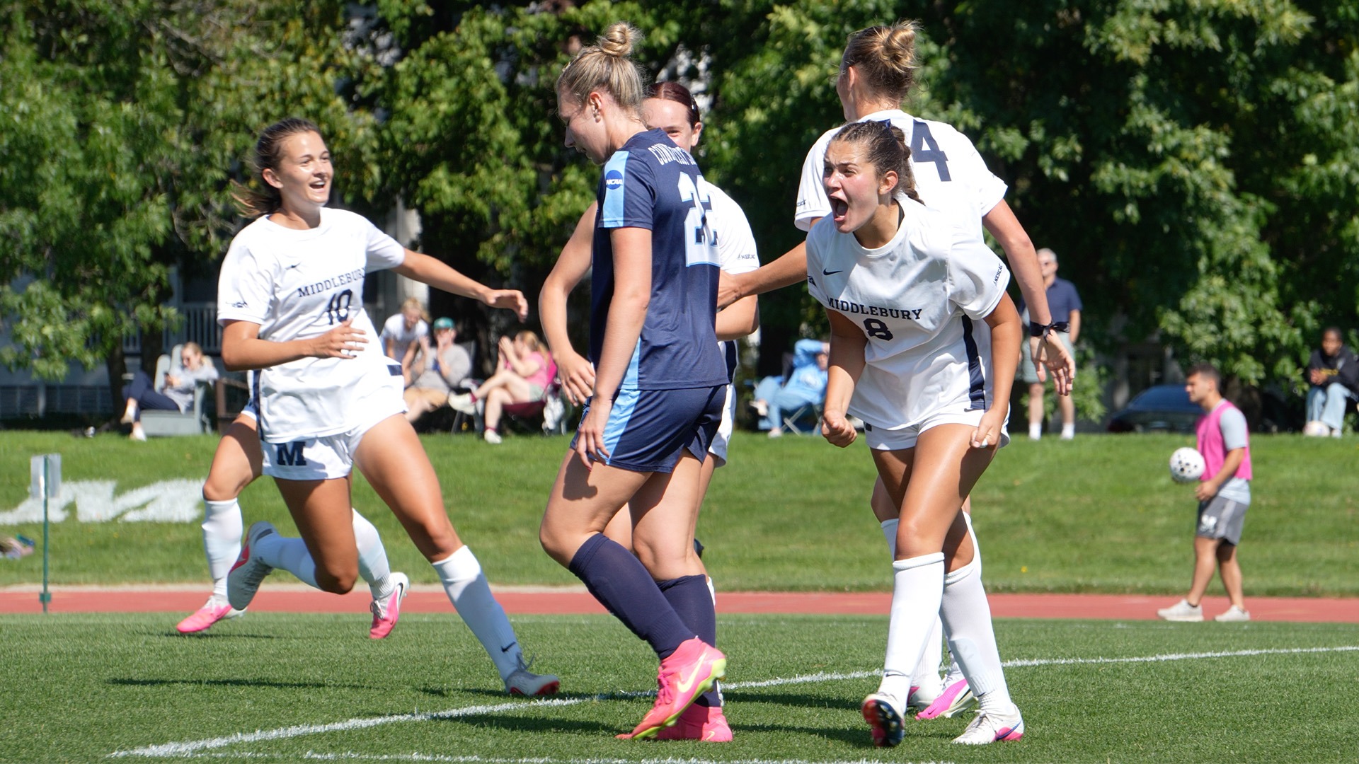 Mia Feldman and Chloe Swindle celebrate after a goal against Connecticut College.