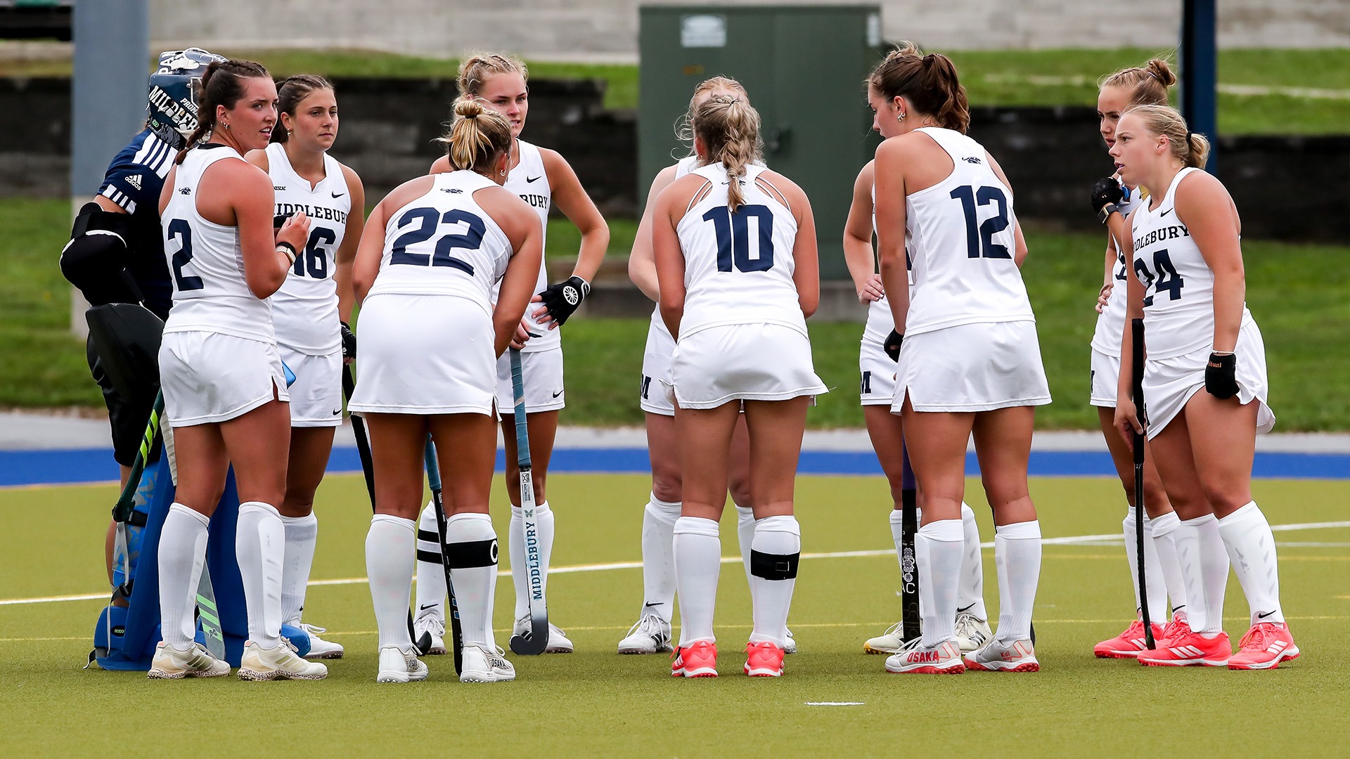 Members of the Middlebury field hockey team huddle during Sunday's game against Babson.