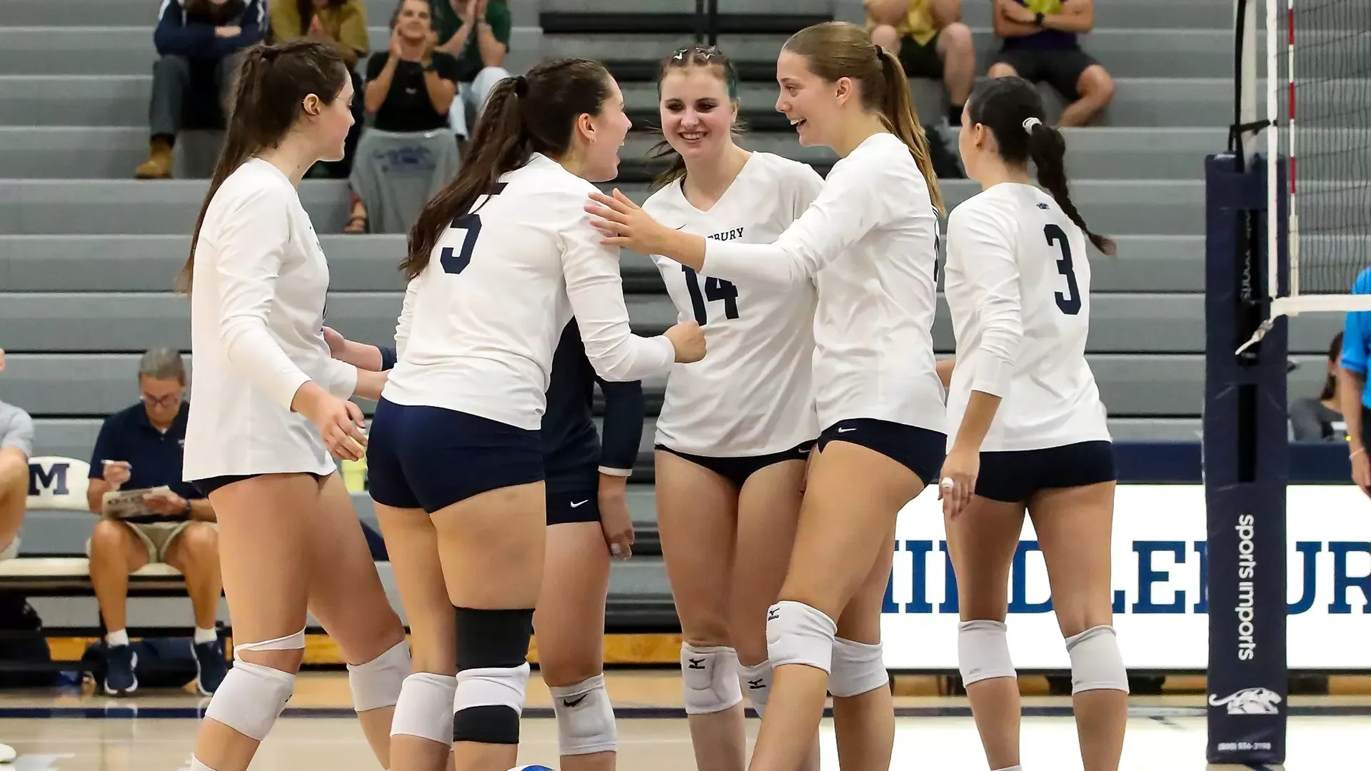Members of the 2026 Middlebury volleyball team huddle after winning a point against Vermont State University Castleton.
