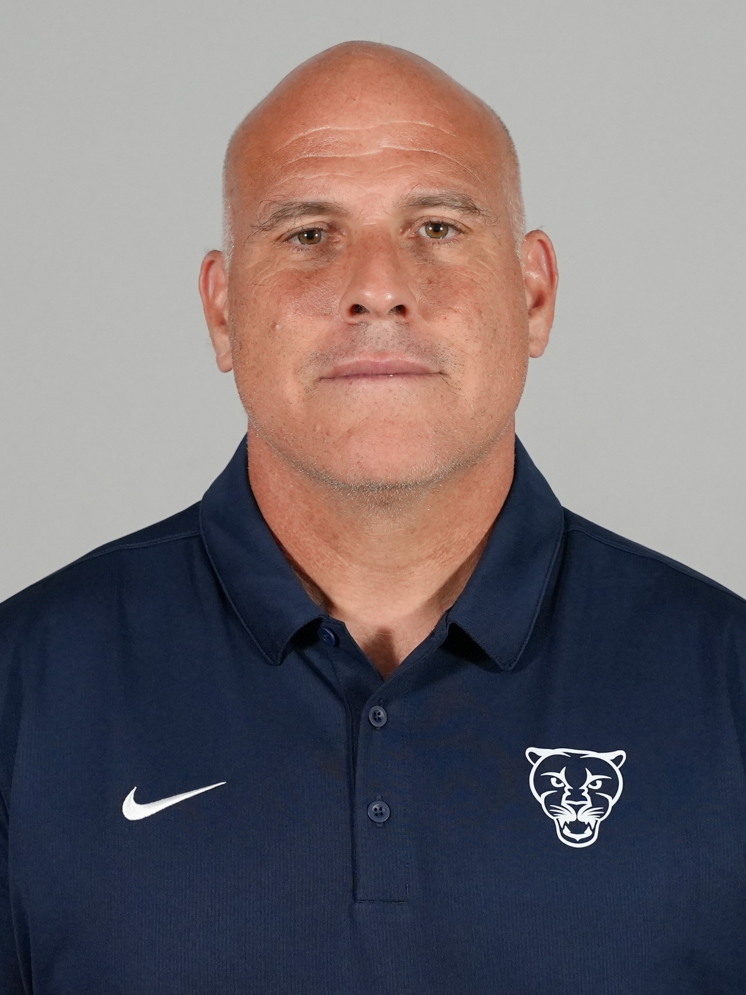 A headshot of Middlebury football coach Doug Mandigo.