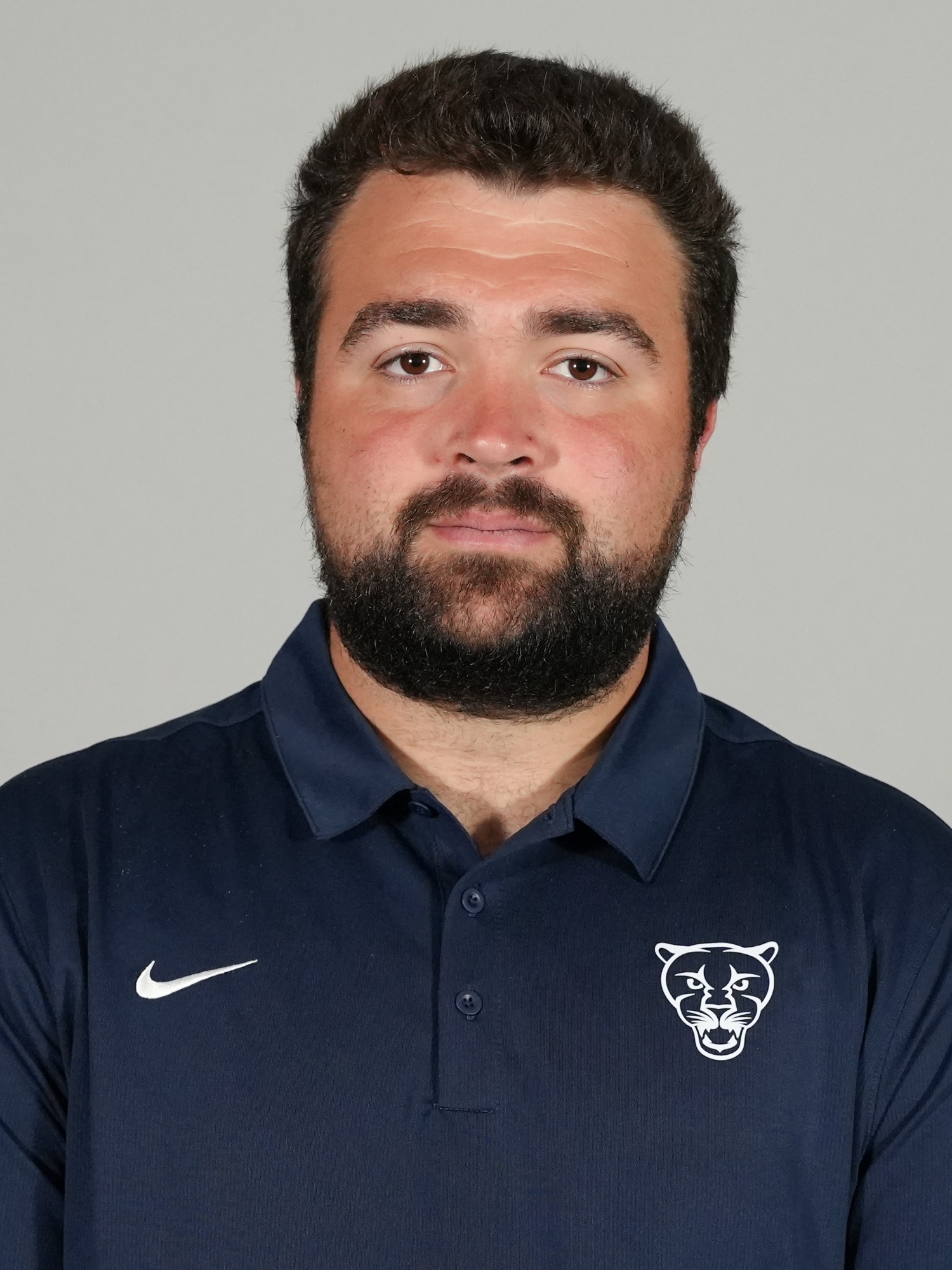 A headshot of Middlebury football coach Patrick Peluso.