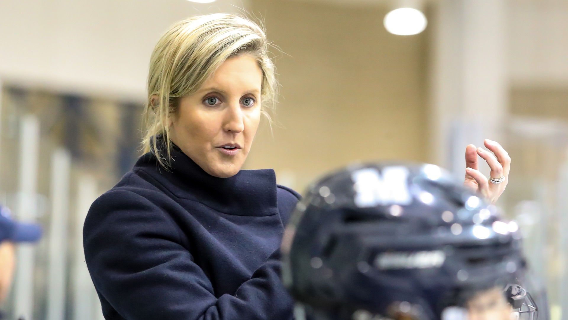 Coach Emily McNamara pictured on the bench during a contest against Bowdoin.