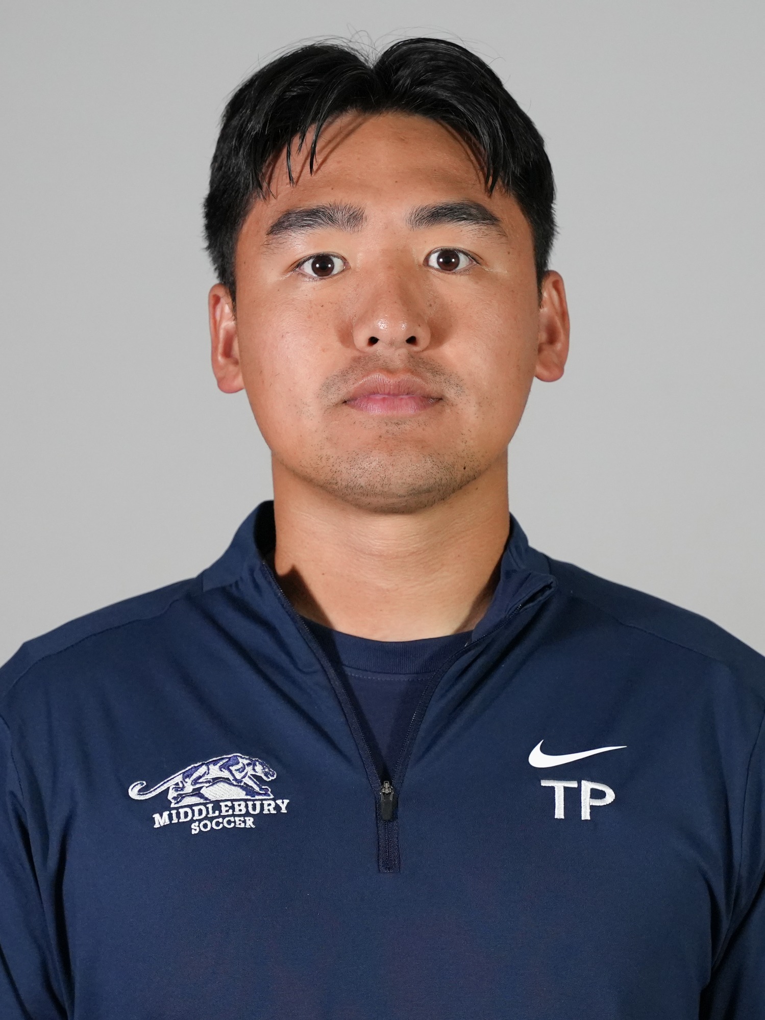 A headshot of Middlebury men's soccer coach Tim Peng.