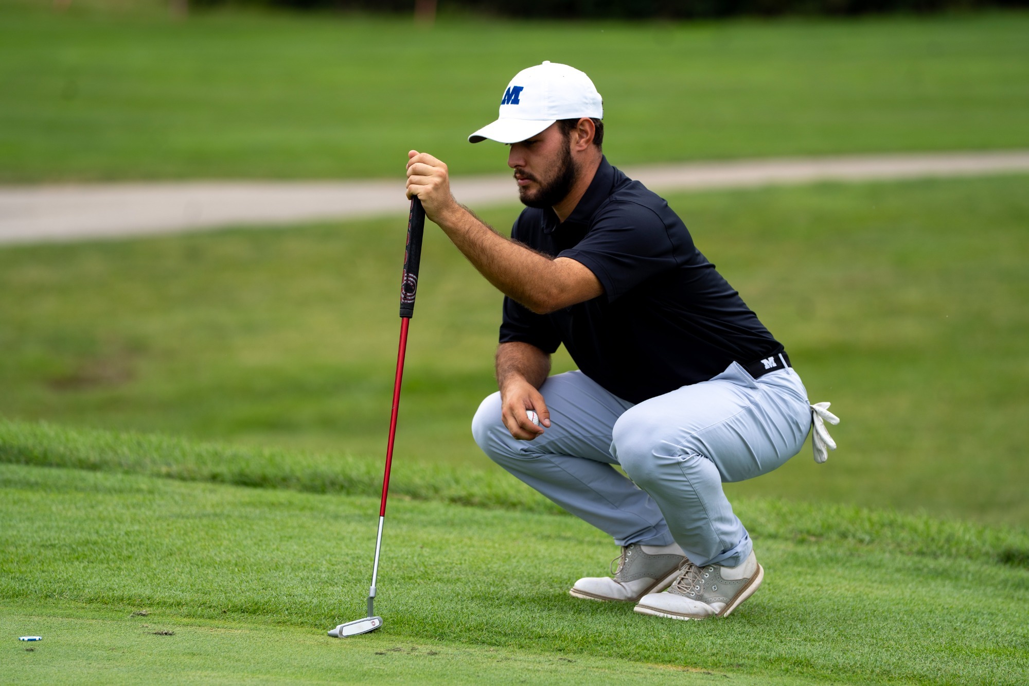 A Grenier lines up a putt