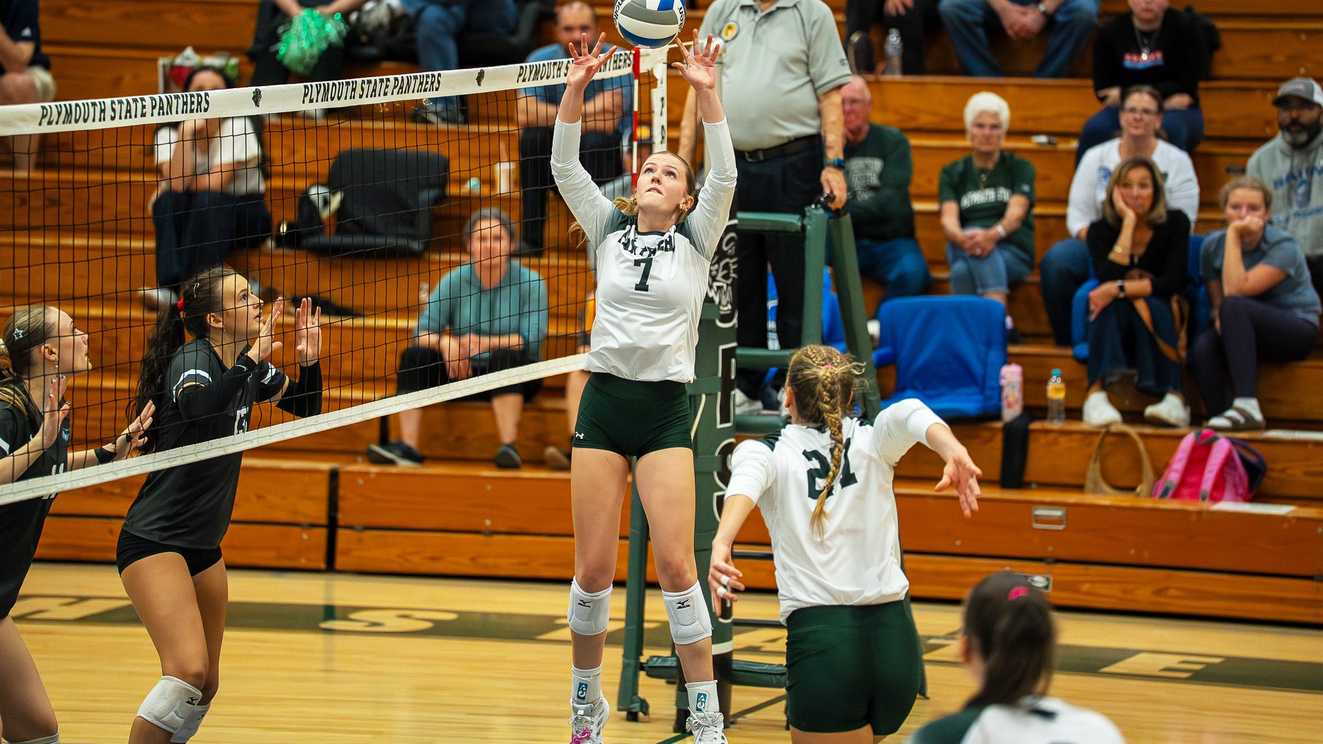 Danielle Emerson jumps to set Sya McKay in a match against Rivier