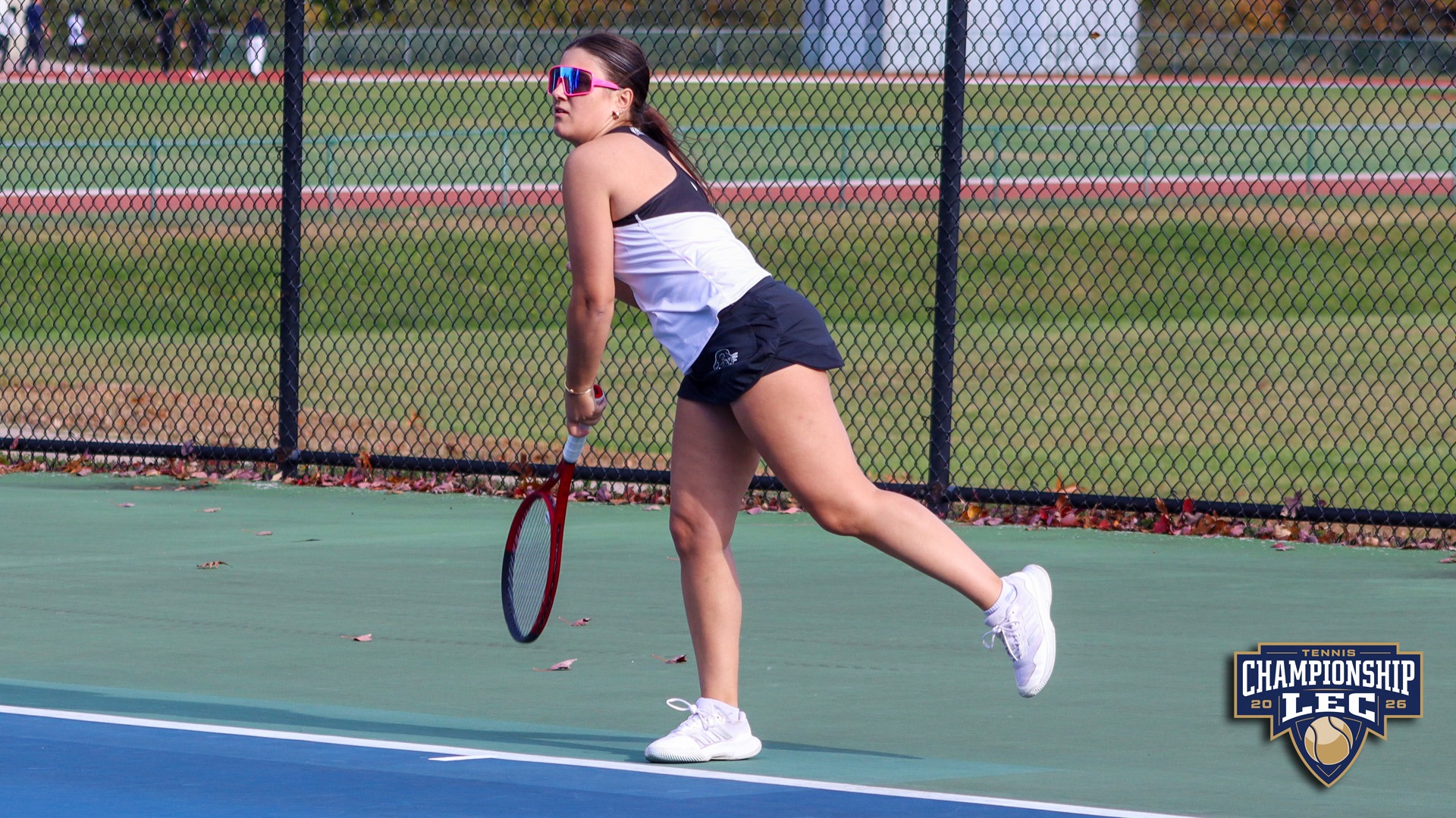Amelia Laidlaw hits a serve against UMass Dartmouth in the first round of the LEC Women's Tennis Tournament