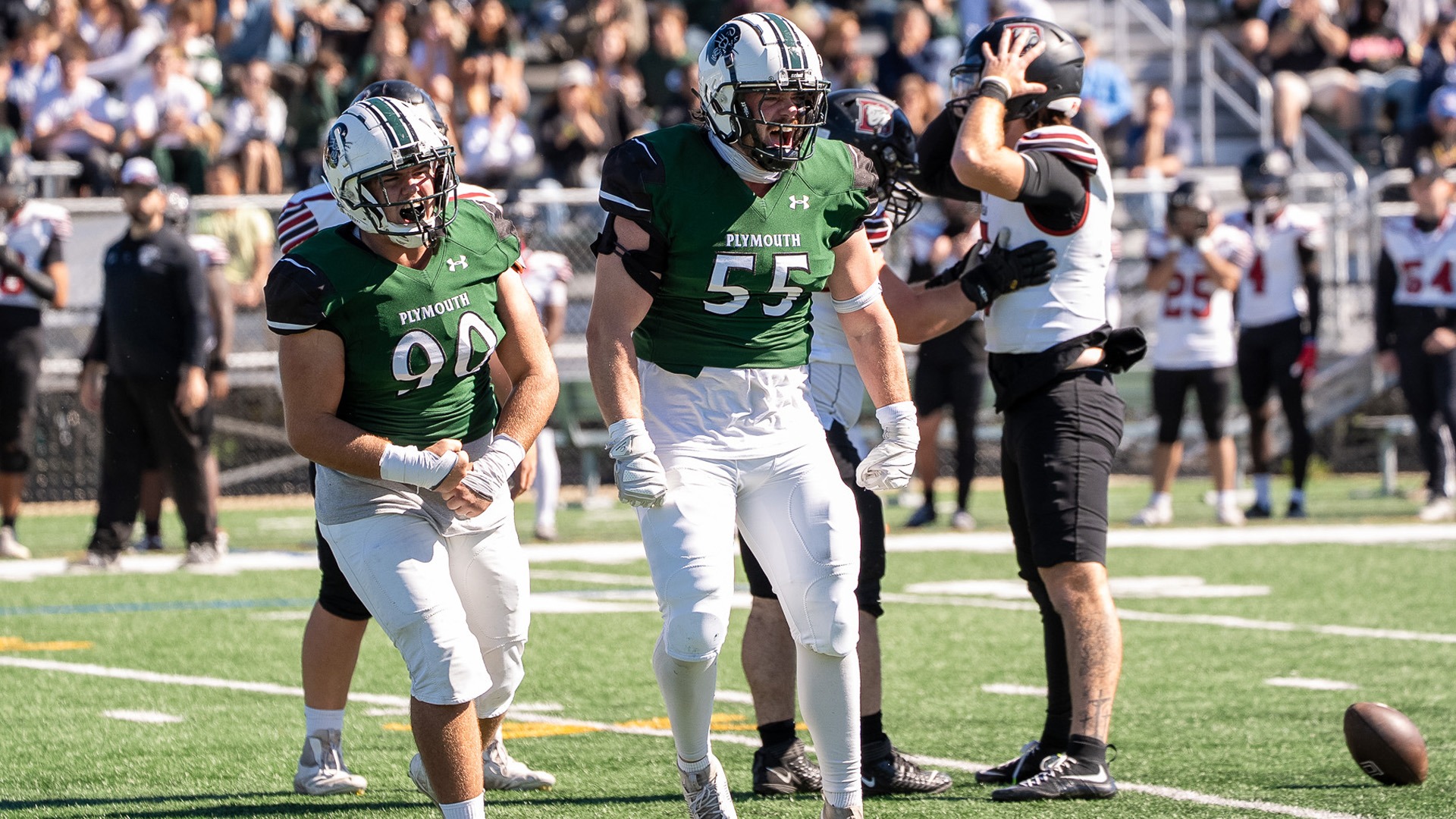 Pierce Heim (right) and Shane McCormick (left) celebrate Heim's sack against Dean