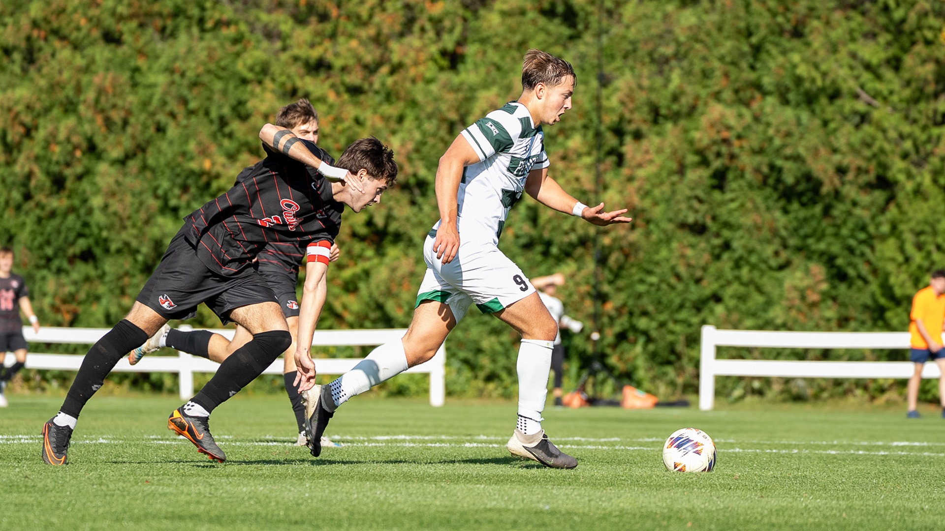 Luke McLaughlin muscles past a defender to score against Keene State