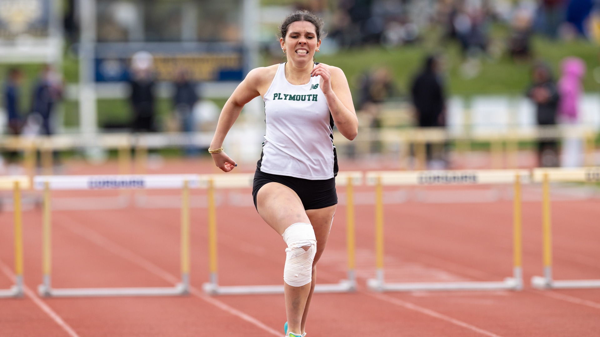 Megan Moynihan competes in the hurdles