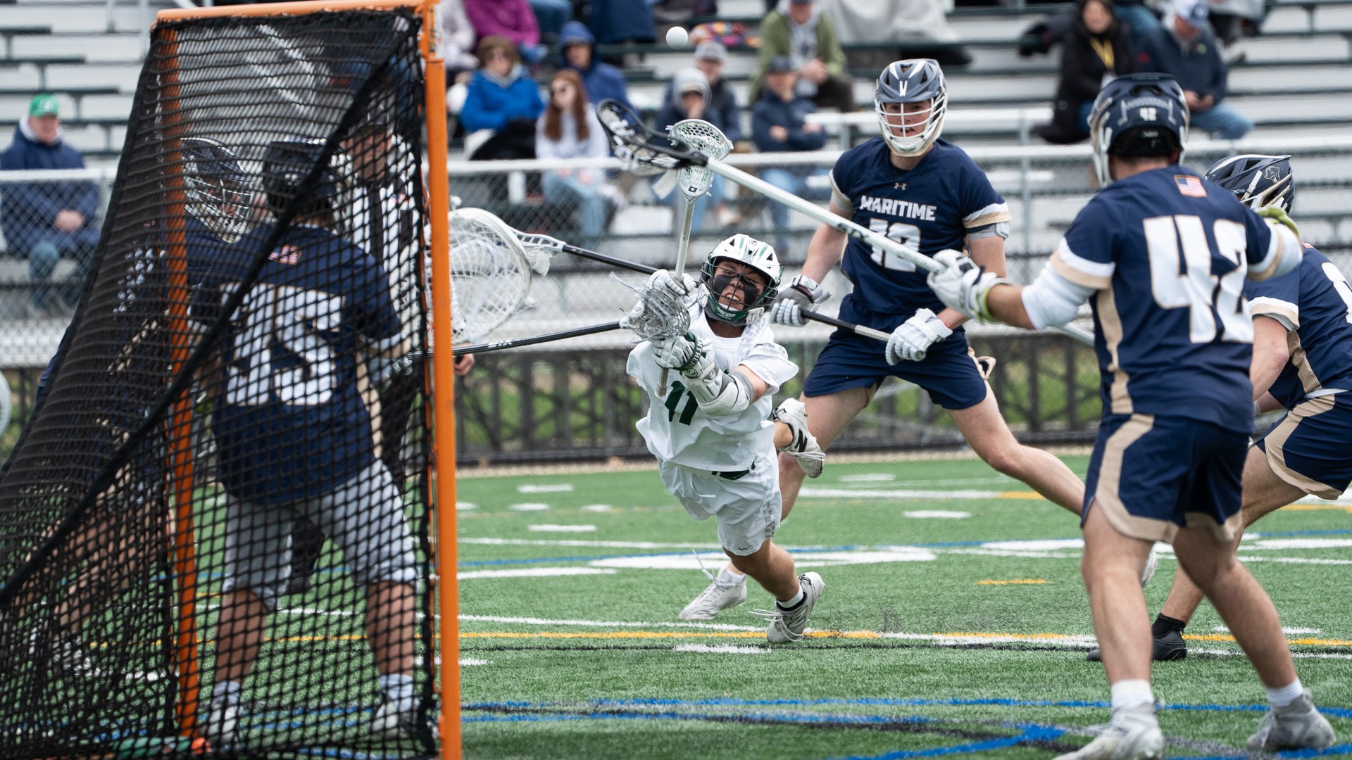 Aiden Renner dives to shoot against Mass Maritime