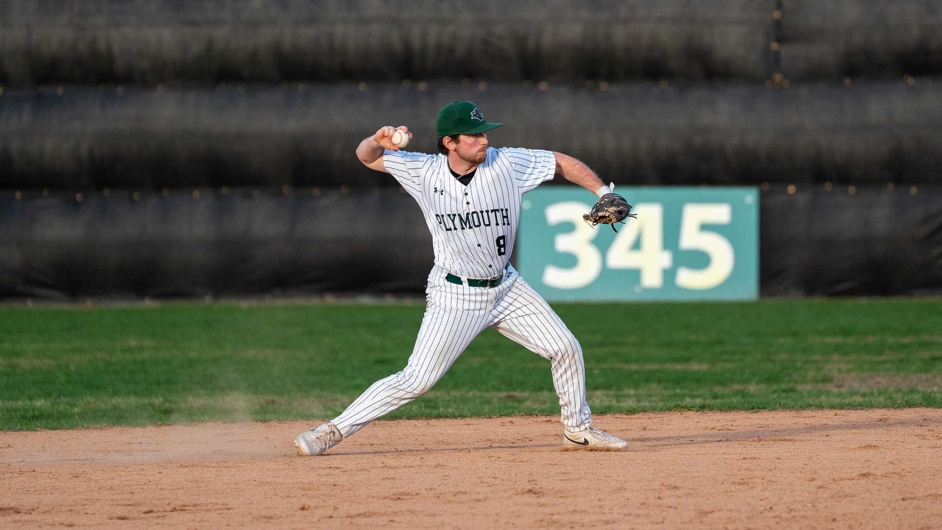 Connor Dobson makes a throw to first base
