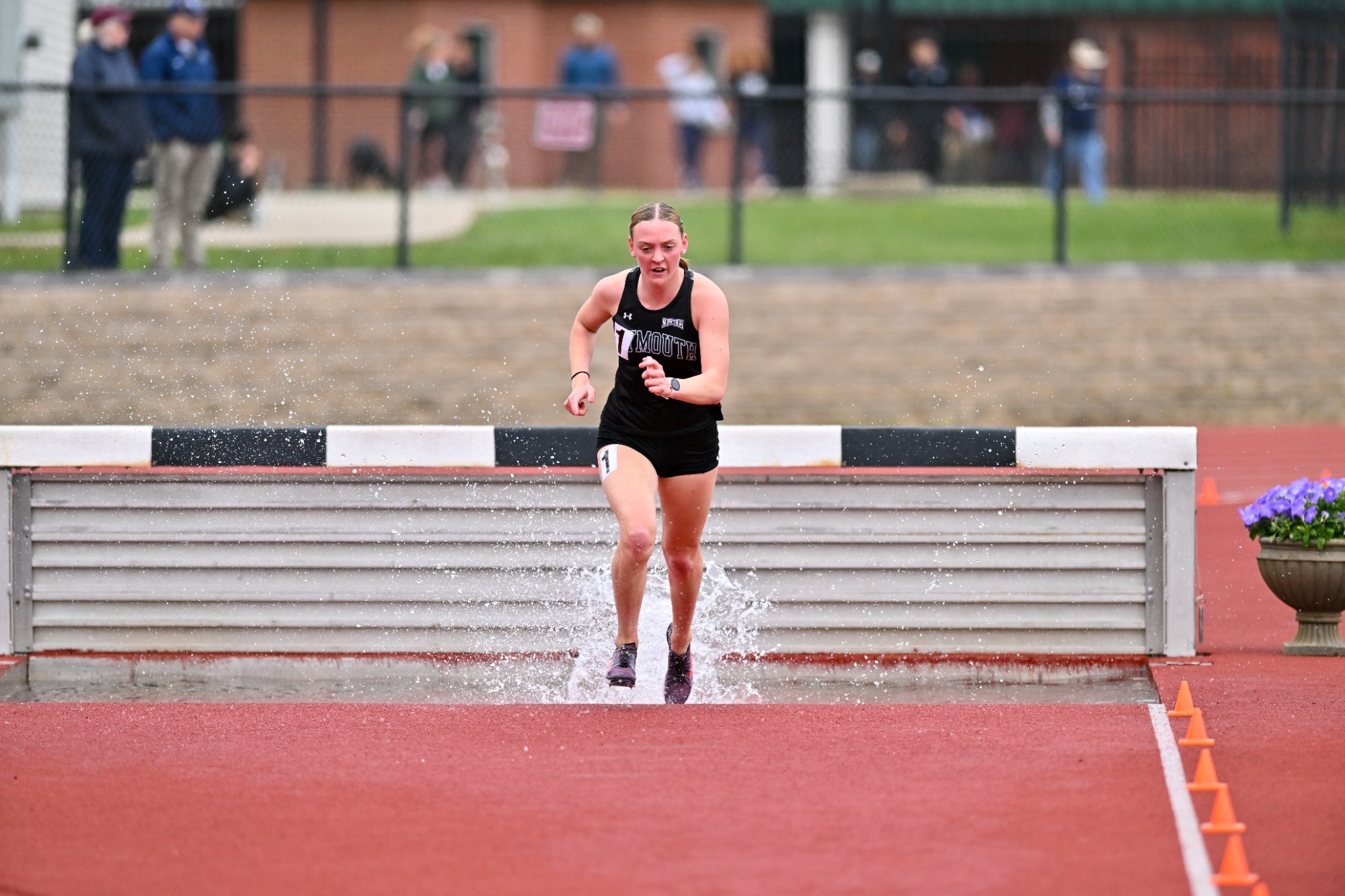 Mia Sweeney competes in the 3,000-meter steeplechase at the LEC Championship