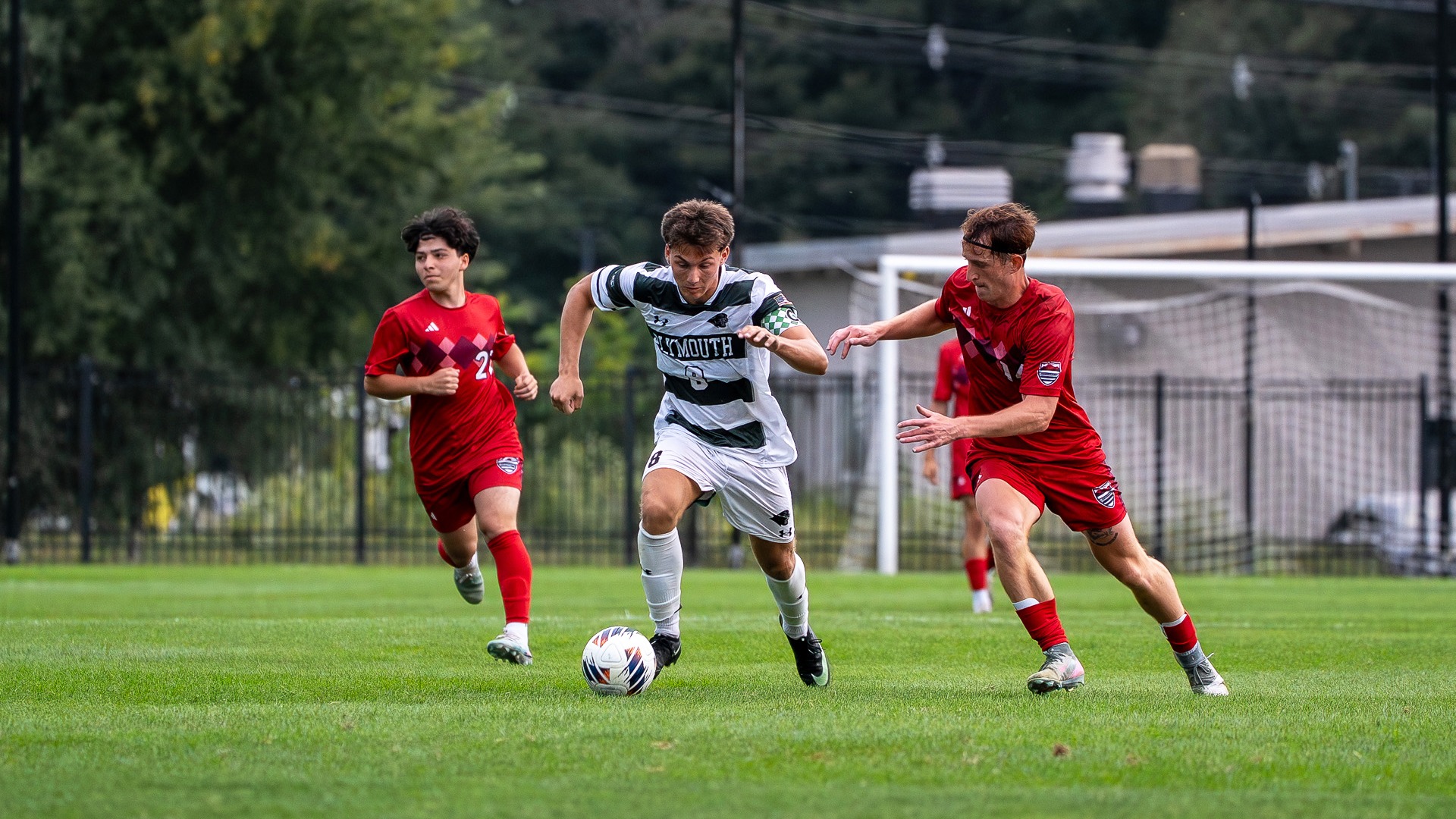 Nick Ferro dribbles past a defender against NEC