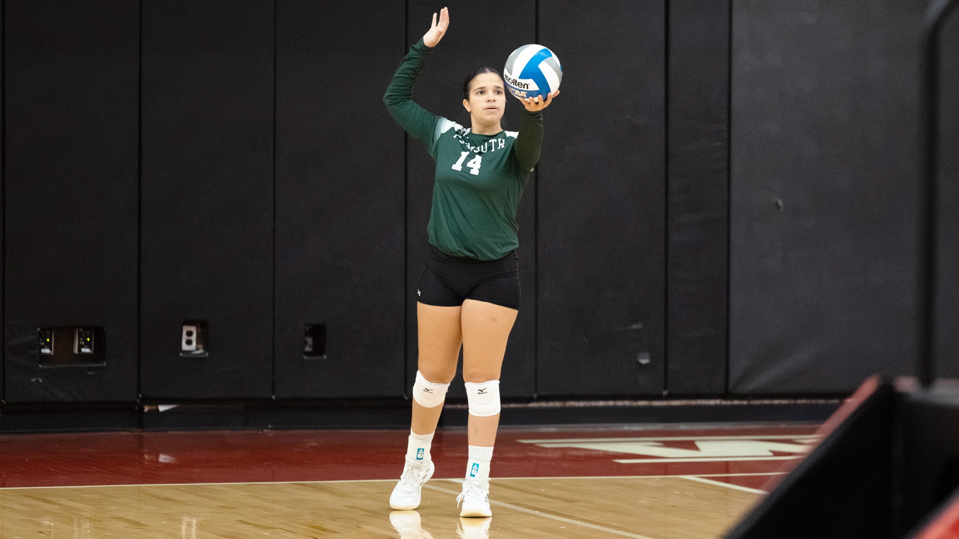 Emily Sousa lines up a serve against WPI