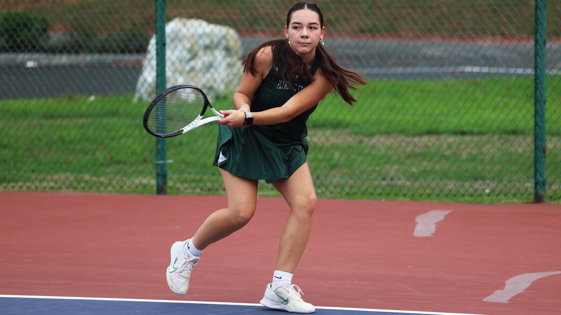 Lauryn Corrigan hits a backhand in a win against Southern Maine