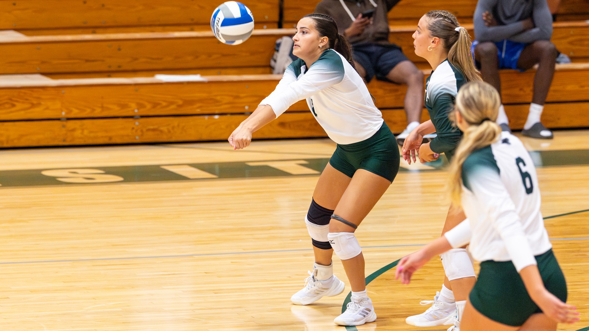Maddie Andrade receives a serve