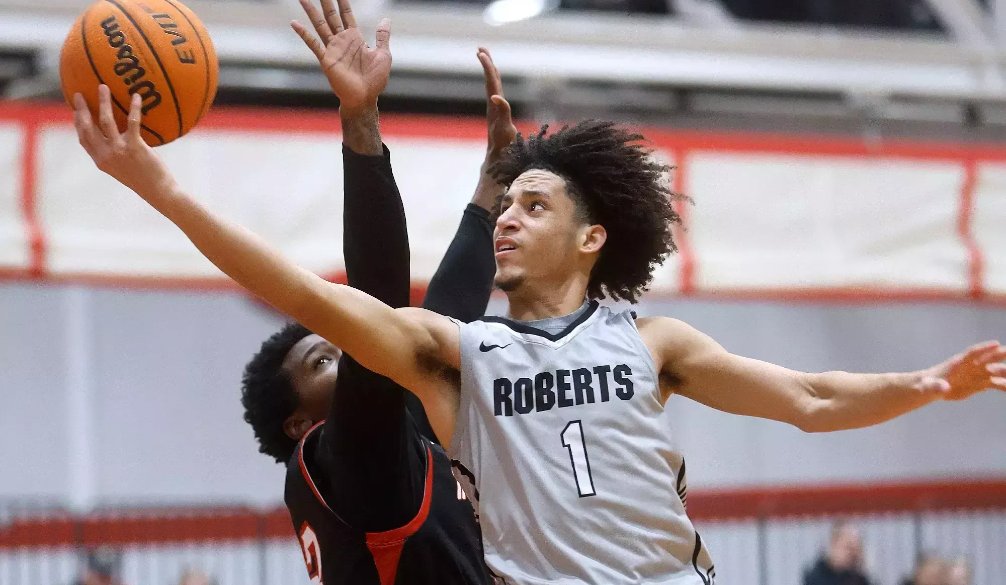 Jordan Brown swoops to the basket to attempt a layup against Mansfield