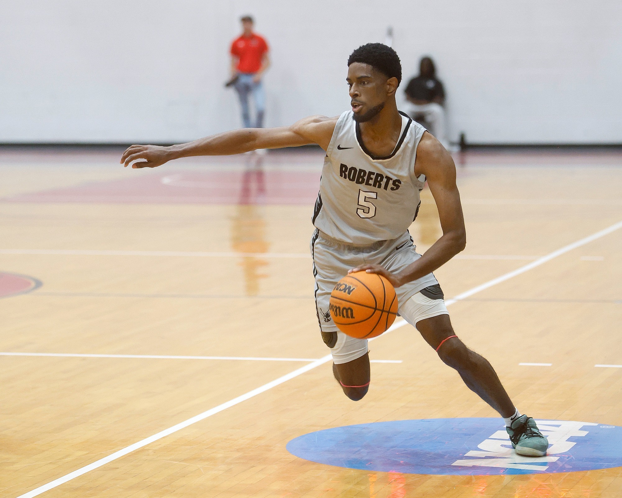 Collin Woods Action dribbles the basketball during a game against Mansfield.