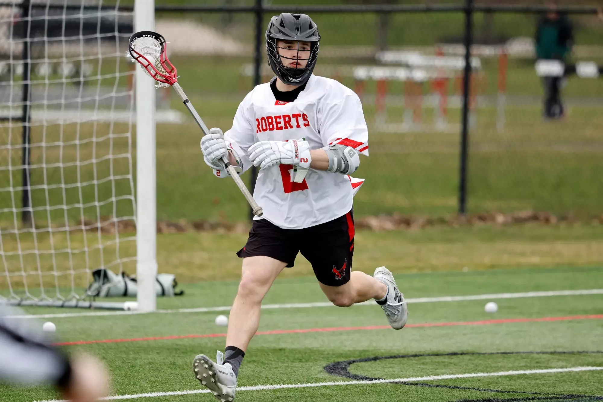 Chase Wilson cradles the ball against Lake Erie College on March 25, 2026.