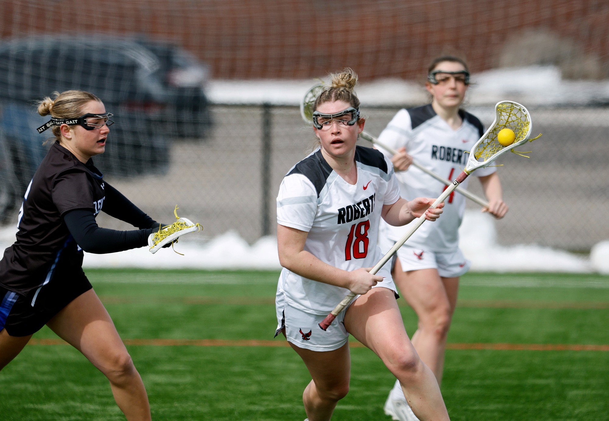 Lia MacDougall carries the ball along the sideline in a game against Bentley on Feb. 28, 2026.