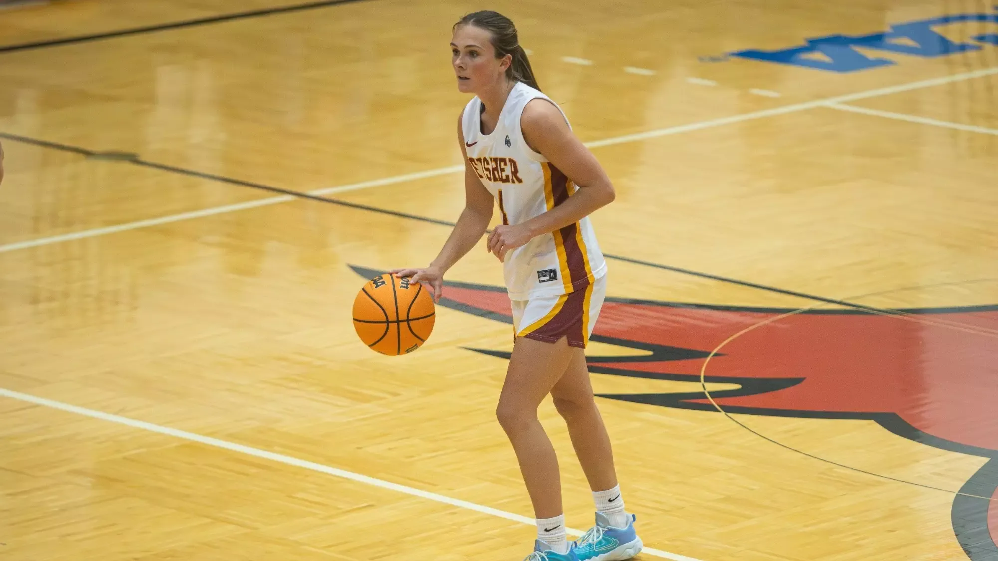 Presleigh Brunner dribbles the basketball at SJF Varsity Gym