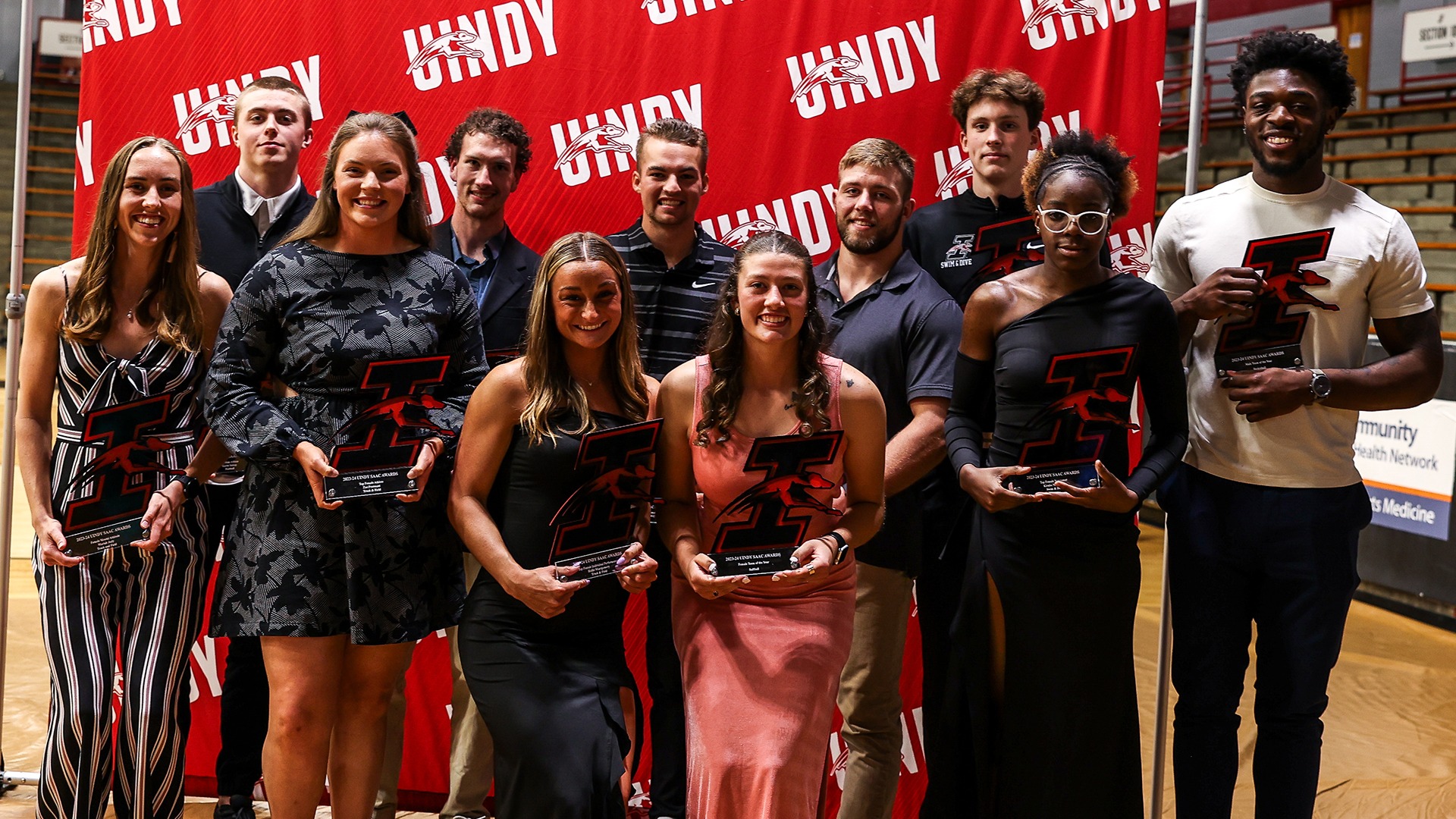 2023-24 SAAC award winners pose for a picture in front of the back drop after the ceremony.