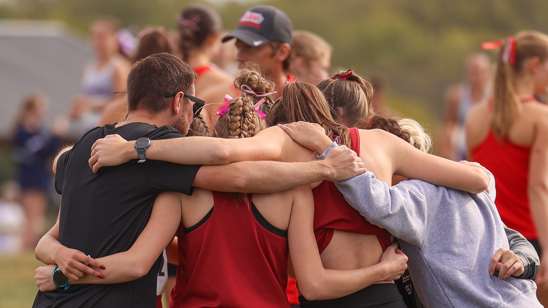 The UIndy women's cross country team huddles before a race. 