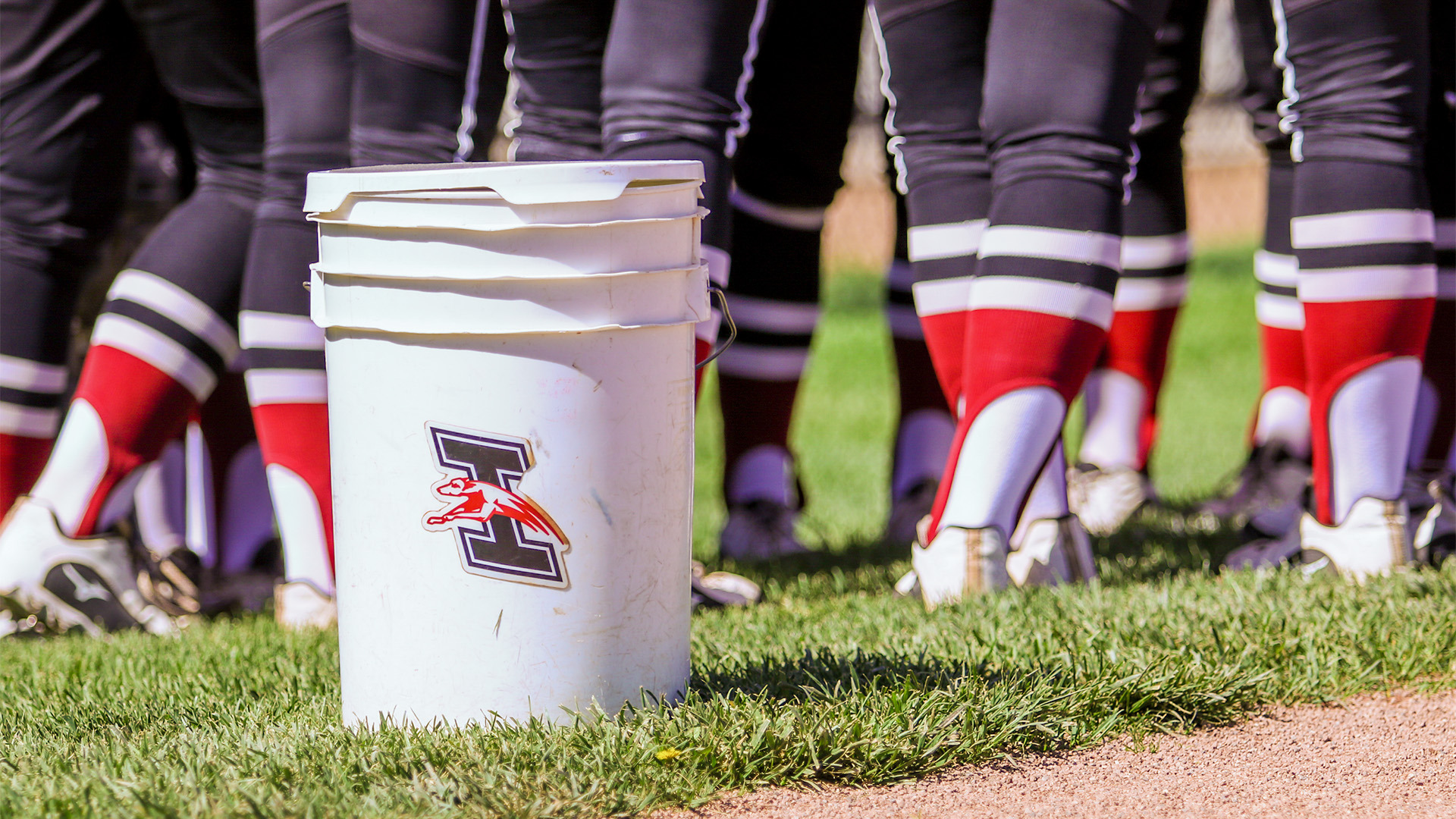 A five-gallon bucket with the UIndy Athletics logo stickered on it.