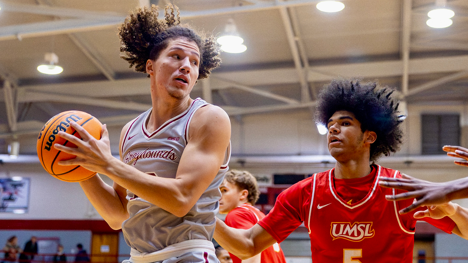 Sean Arnold drives to basket through UMSL player